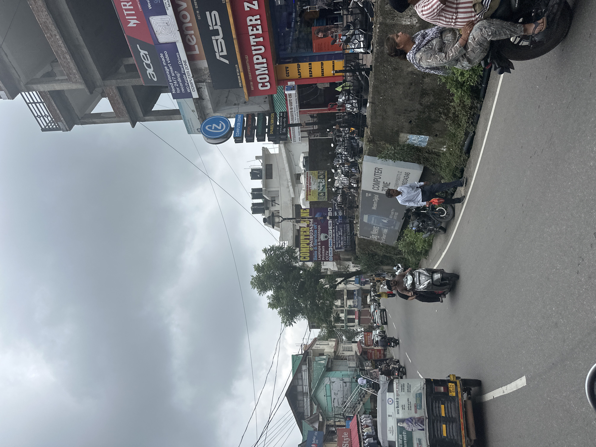Scooter commute through a hilly Indian city on a cloudy morning