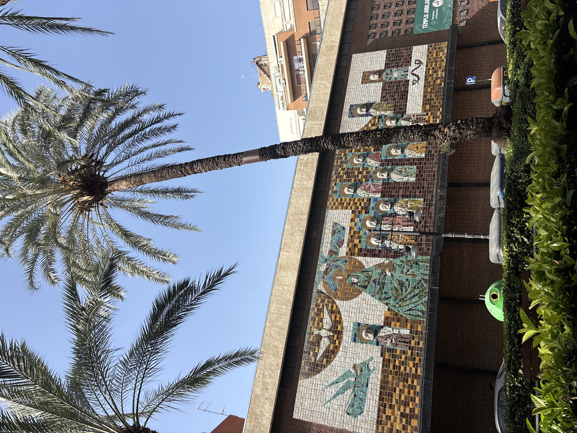 E-scooter ride past a mosaic-covered building in Valencia