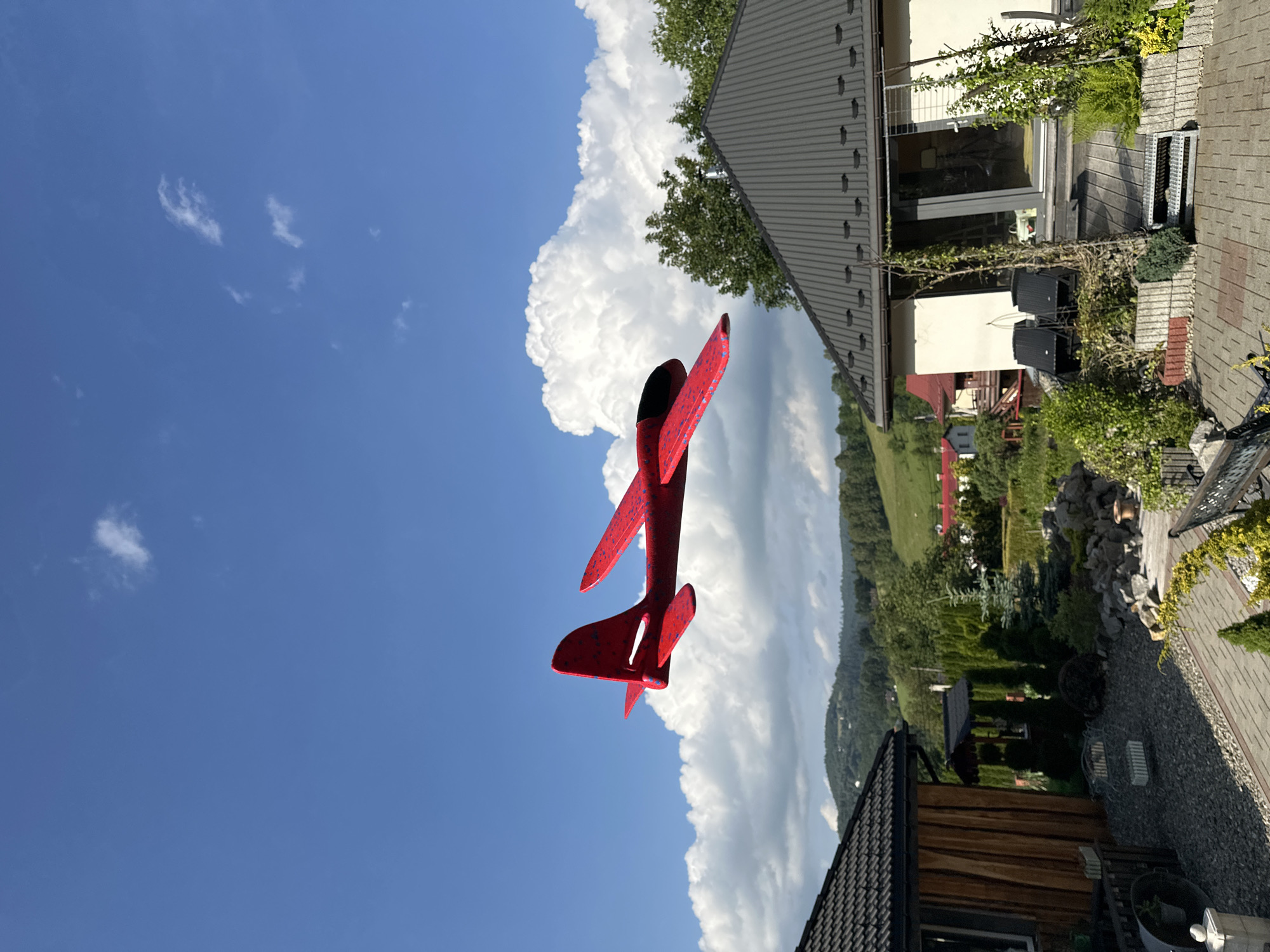 Backyard play and toy airplane flights over hilly Wisła