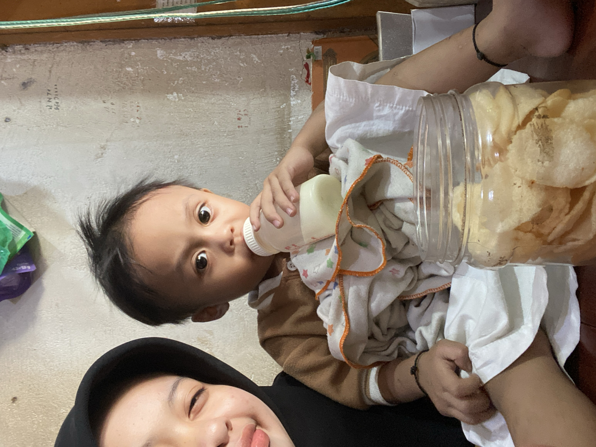 Toddler's day unfolds amid local markets and street life in Ta', Indonesia