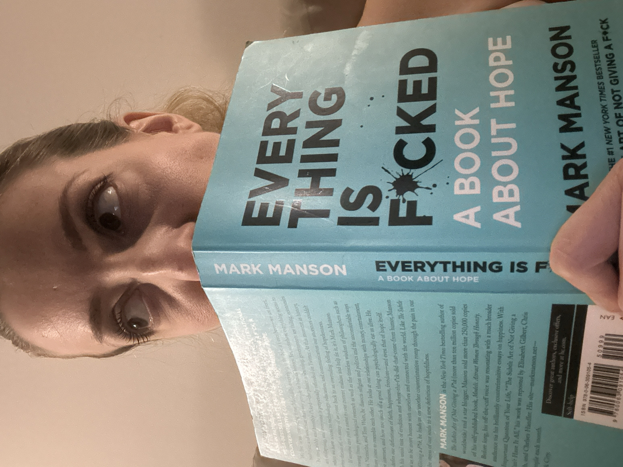 Woman reads Mark Manson book in Amsterdam evening session