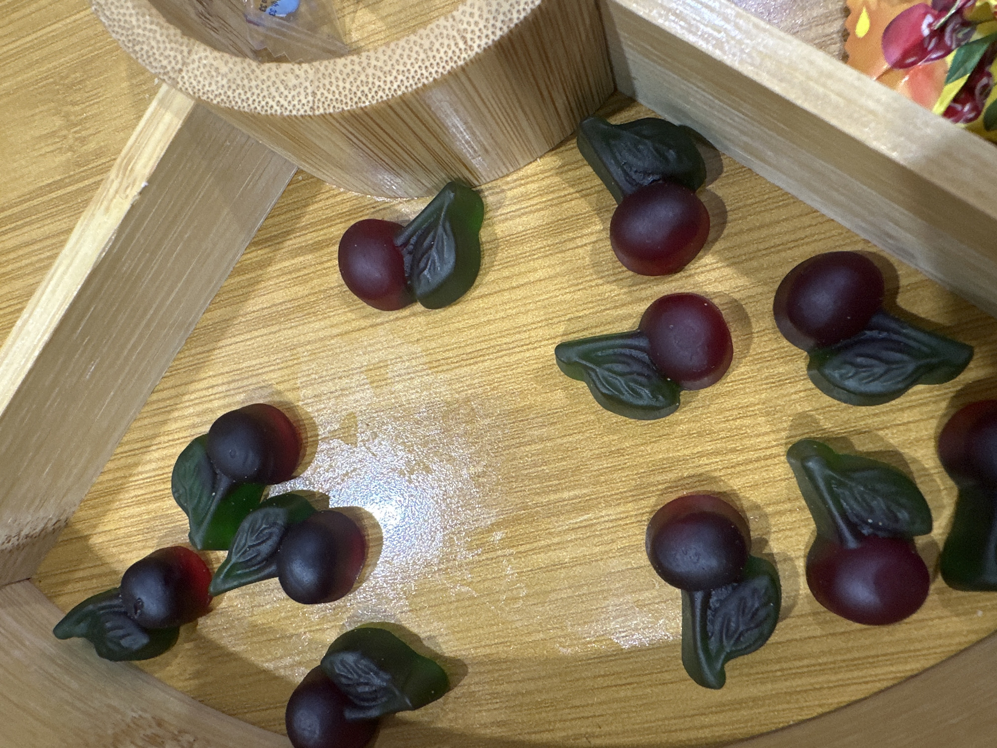 Cherry gummy candies scattered on wooden surface in Yerevan