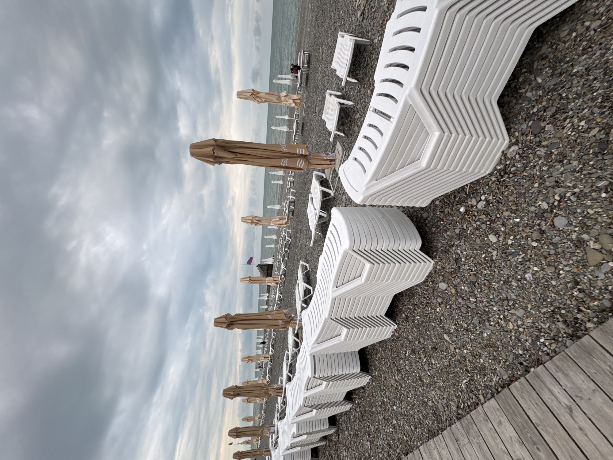 Quiet afternoon captured at Sochi pebble beach under cloudy skies