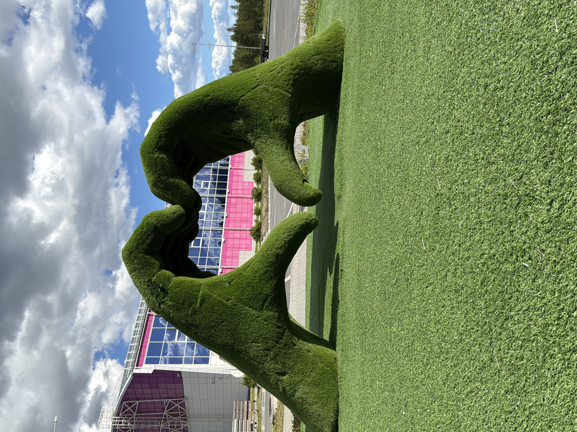 Outdoor sculptures in Polarnye Zori: grass hands and metallic panels