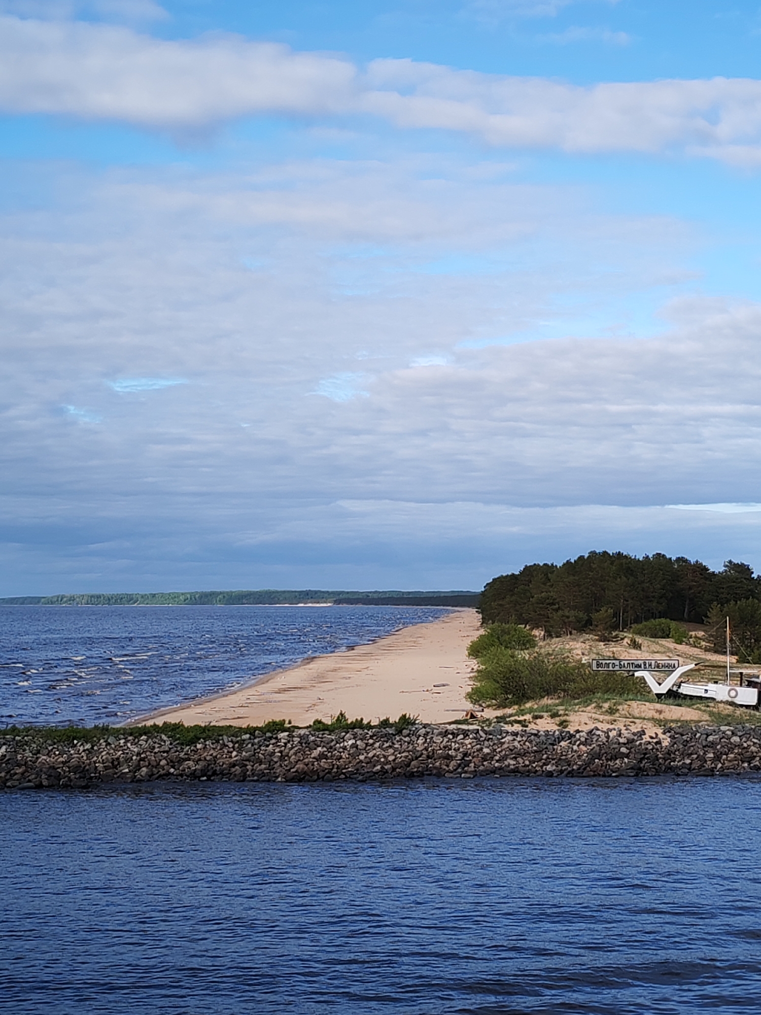 Cargo ship transits Volgo-Balt Canal near Russian lighthouse