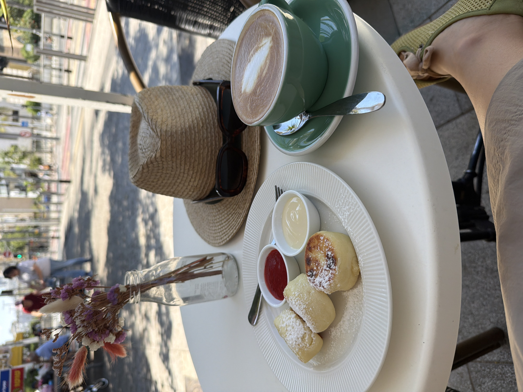 Coffee, a straw hat, and sunglasses at a Bat Yam café