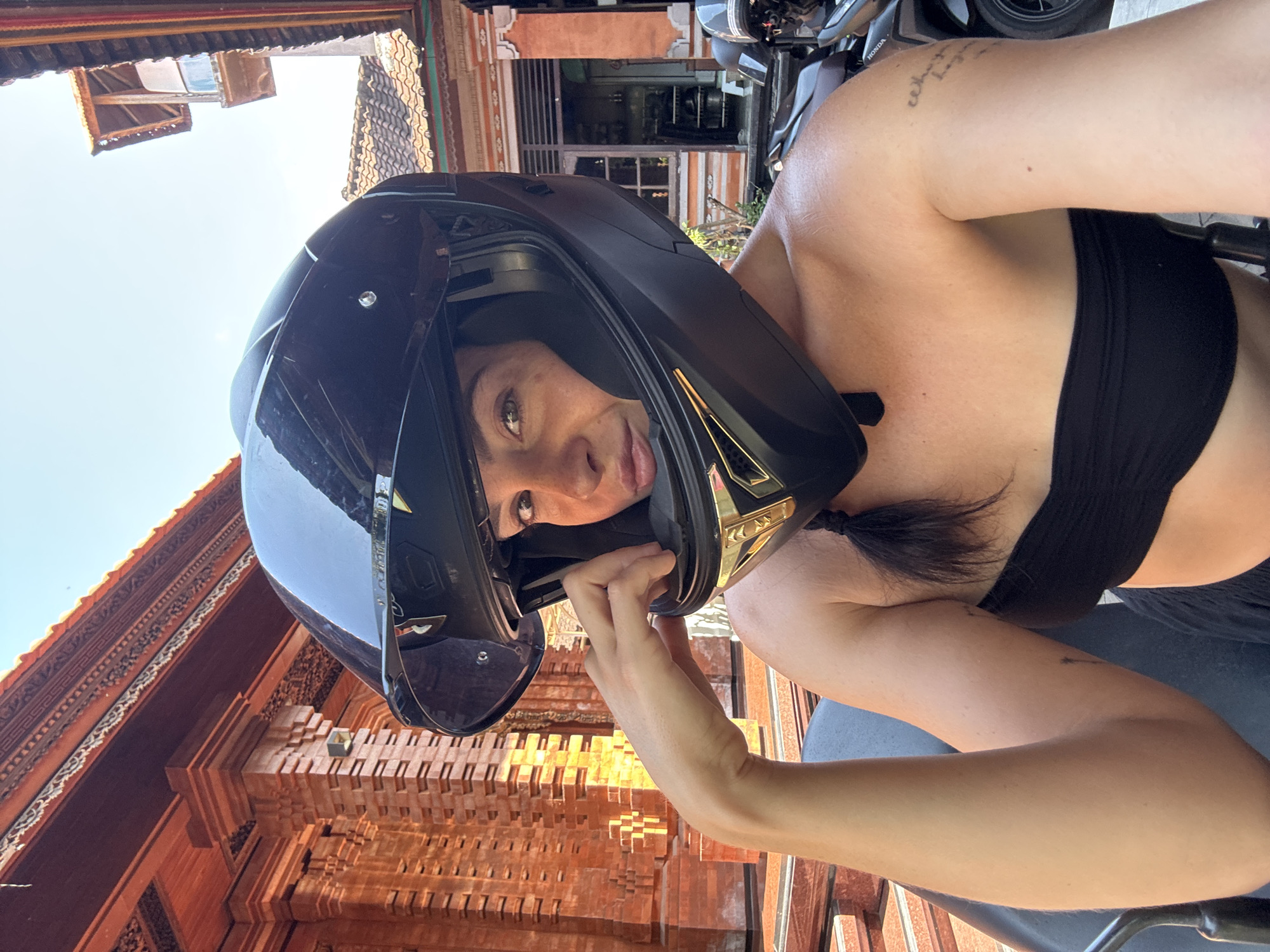 Helmet selfies and a parked scooter in North Kuta, Bali
