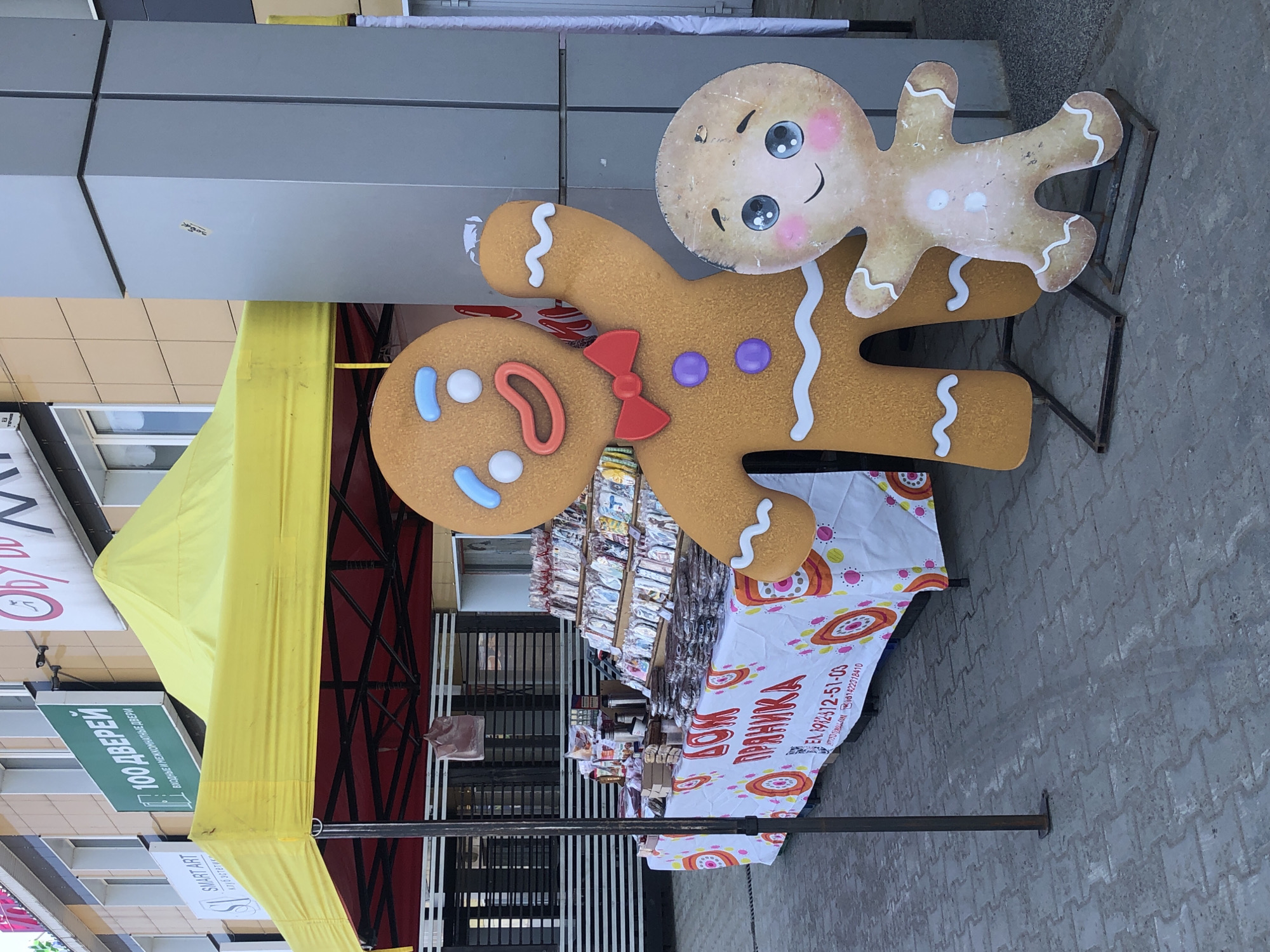 Woman takes selfies near gingerbread market in Chaikovsky, Russia