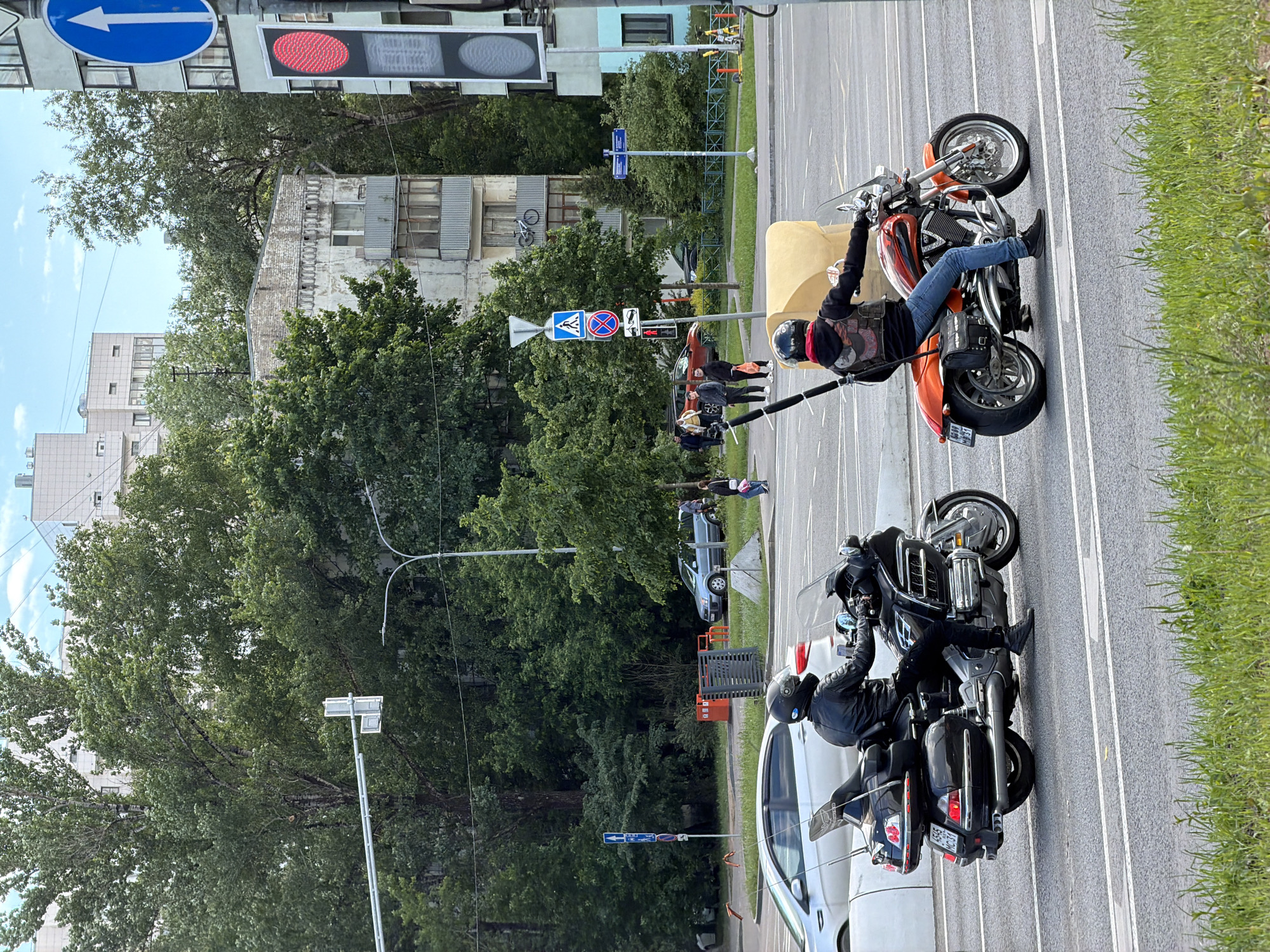 Motorcycles parked on Moscow street with rider and pedestrians