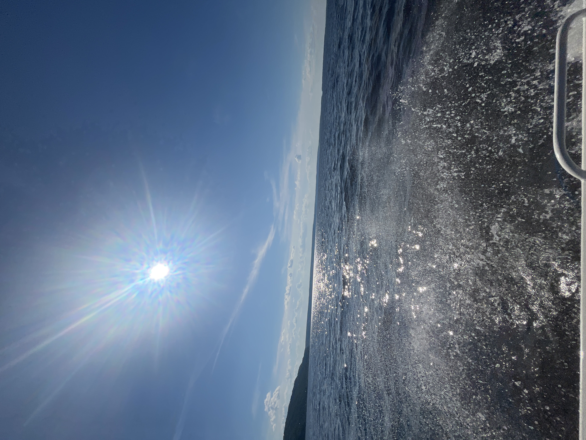 Sunny boat ride across open water near Siukterka, Russia