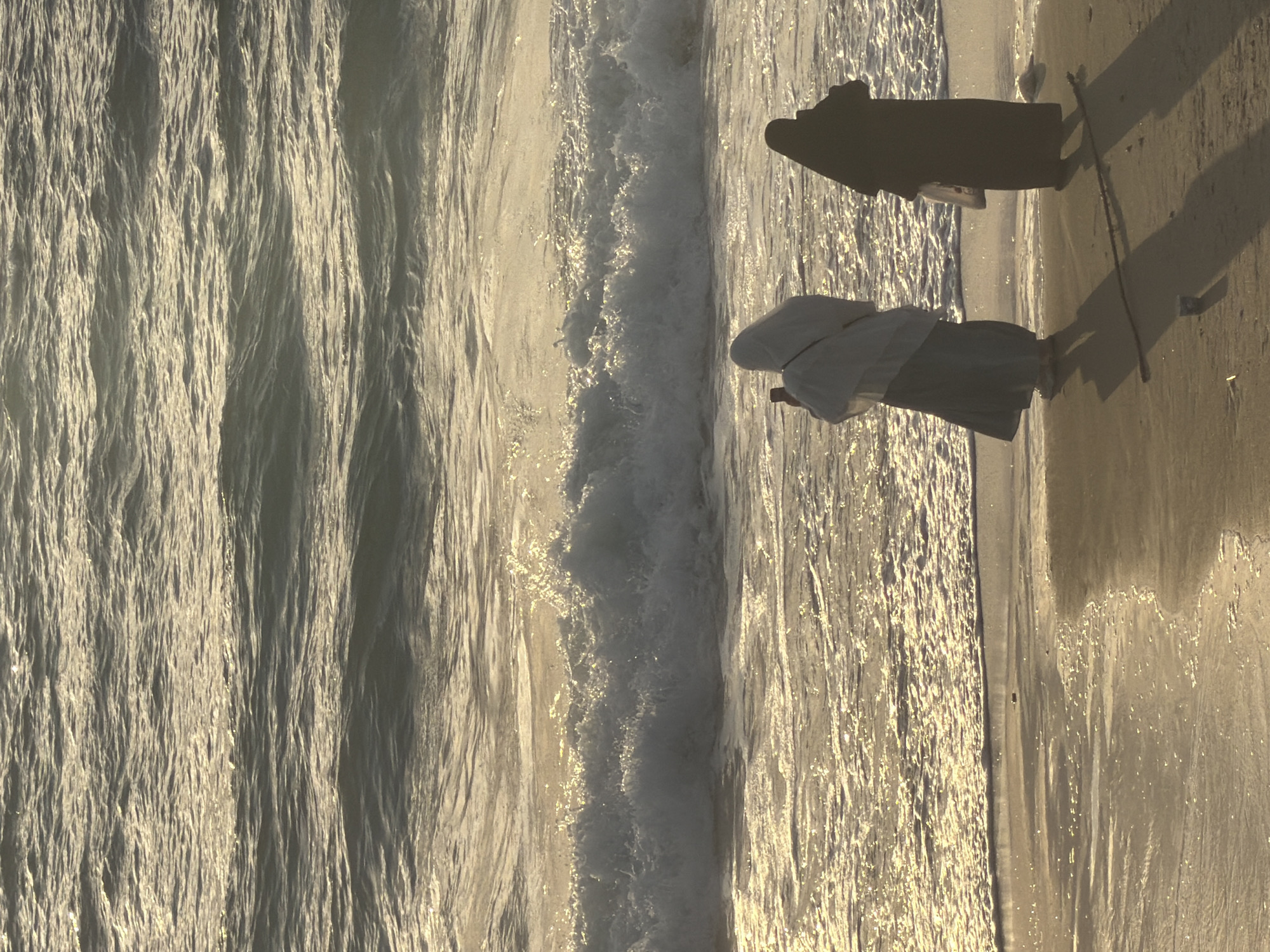 Sunset on the Tel Aviv waterfront — paddleboards, beach, golden light
