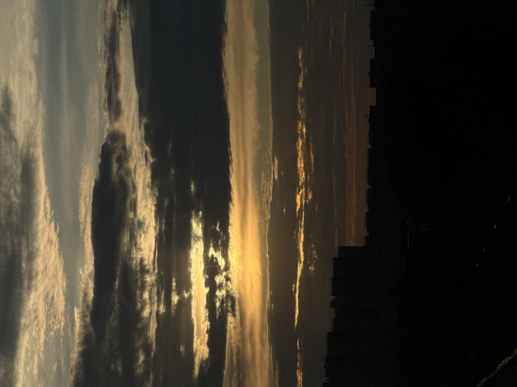 Sunset observed over Nizhny Novgorod skyline with layered clouds