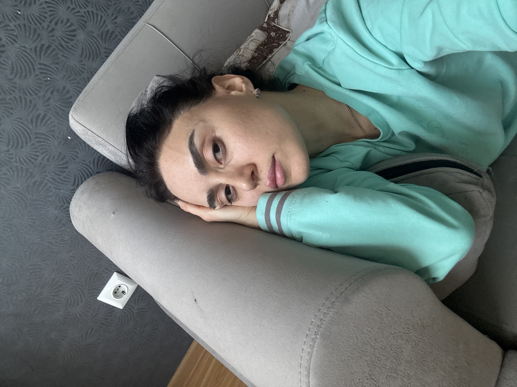 Woman rests on couch in Tbilisi home