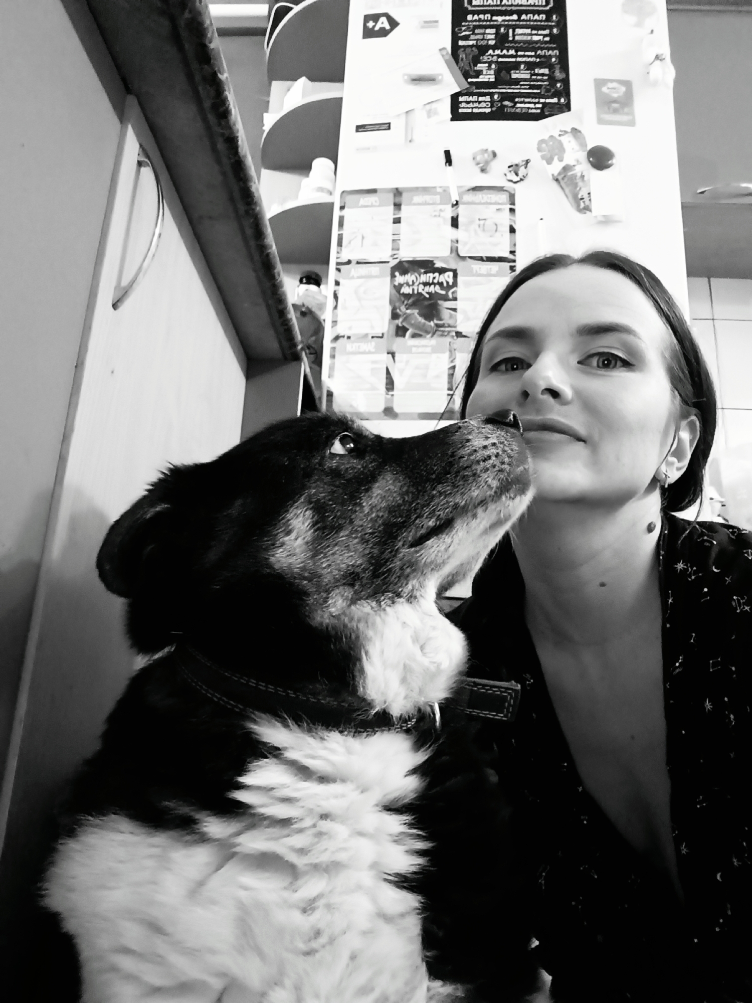 Woman and dog share affectionate moment in Rusalevka home
