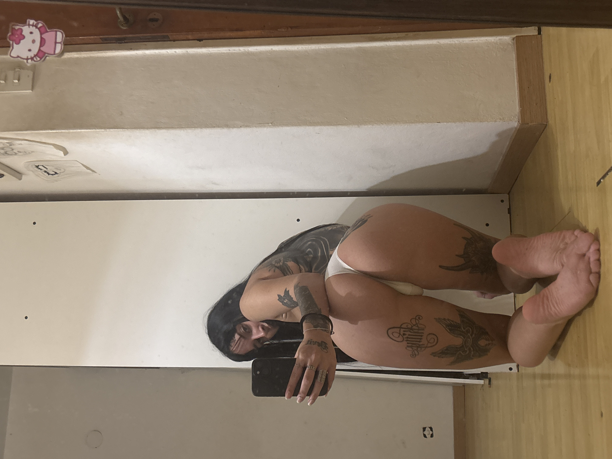 Woman takes floor selfie in Argentine bathroom early morning