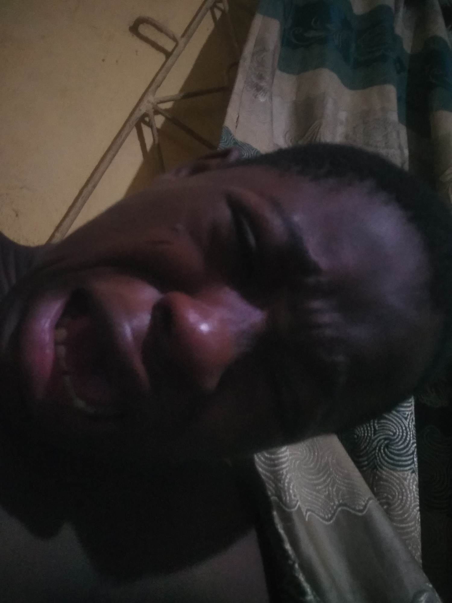 Person photographed on bed in Shangisha Nigeria early morning