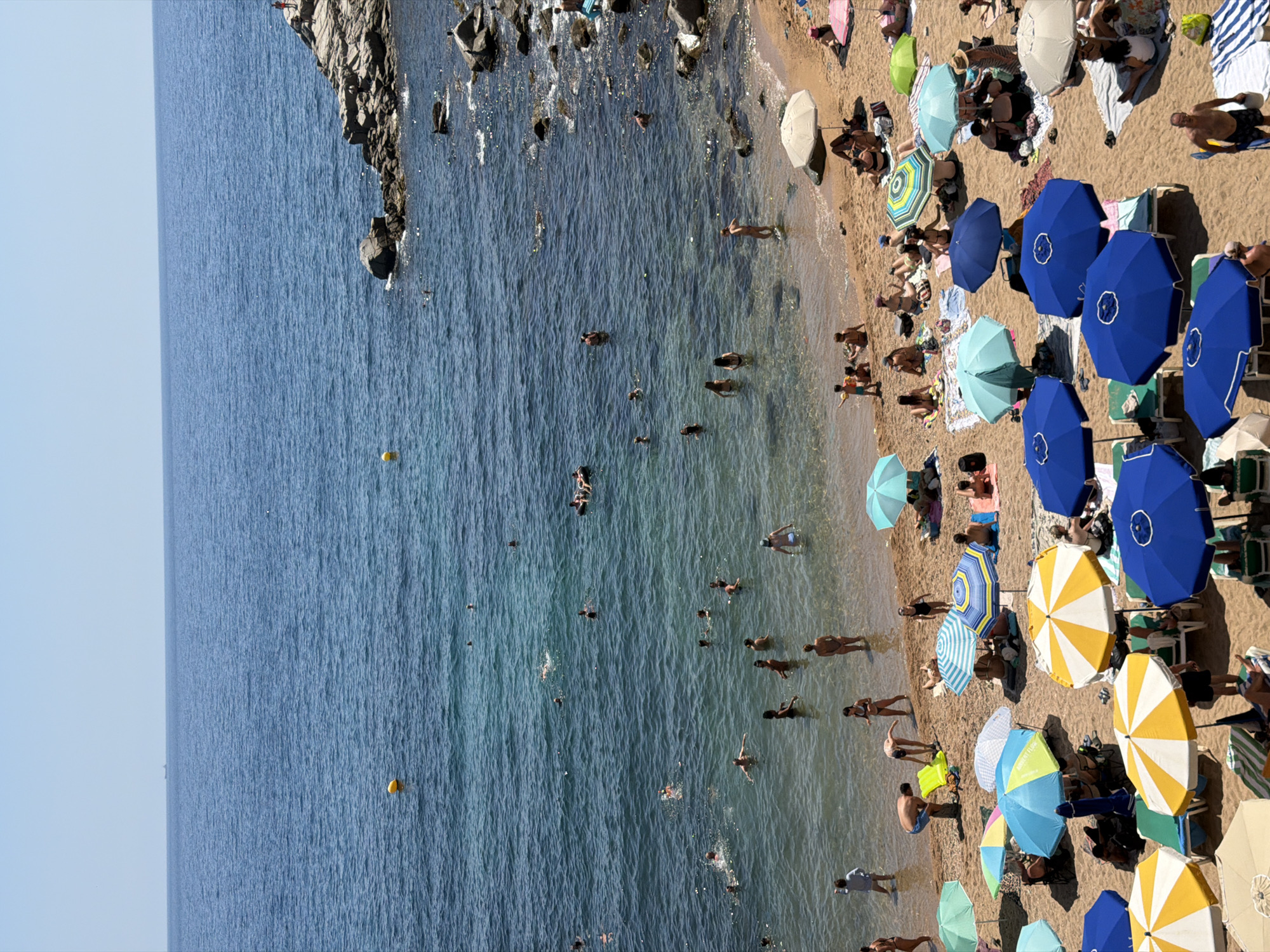Crowded summer beach day on the Costa Brava