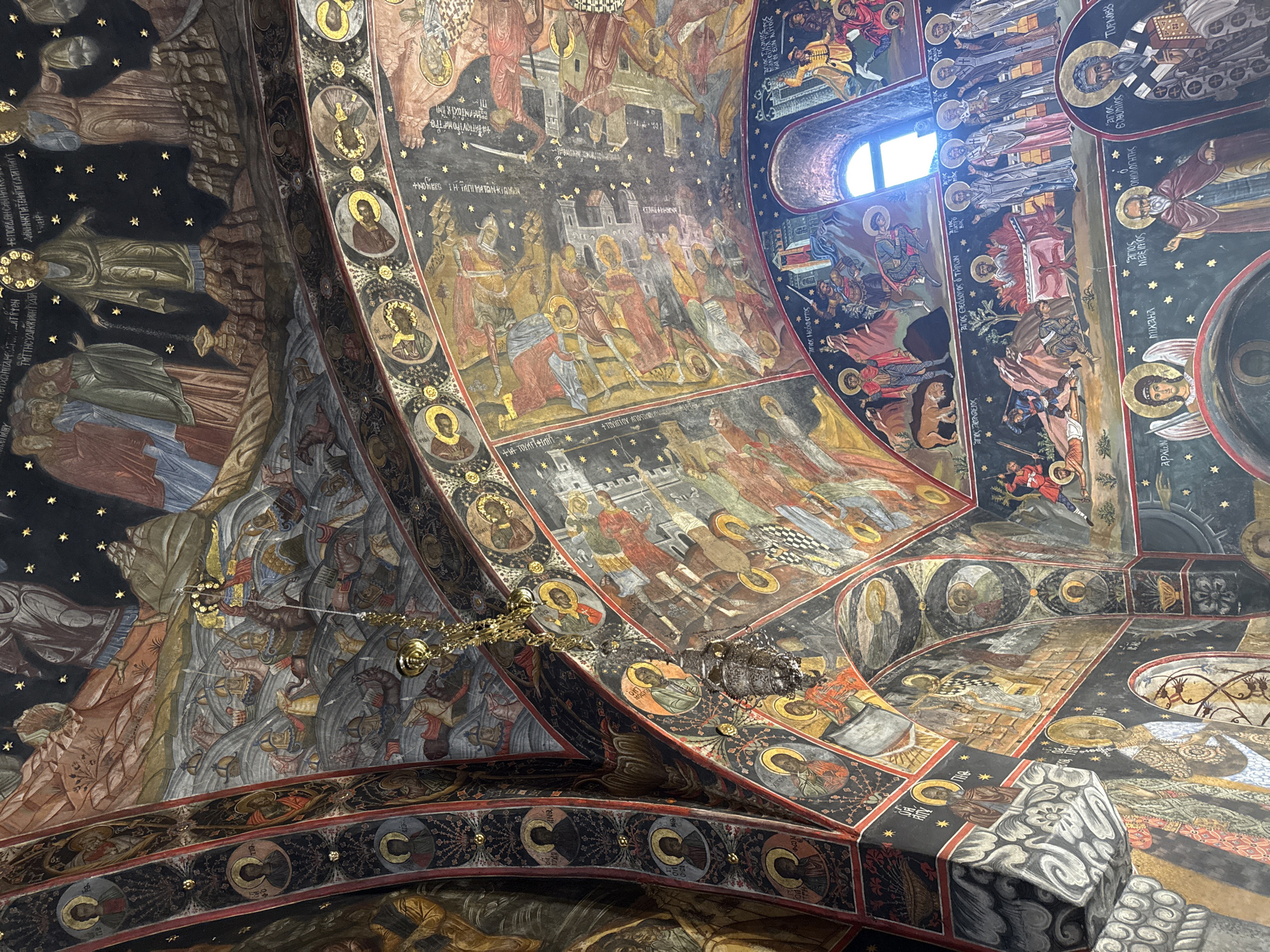 Visitor documents ornate frescoes at Bulgaria's historic Bachkovo Monastery