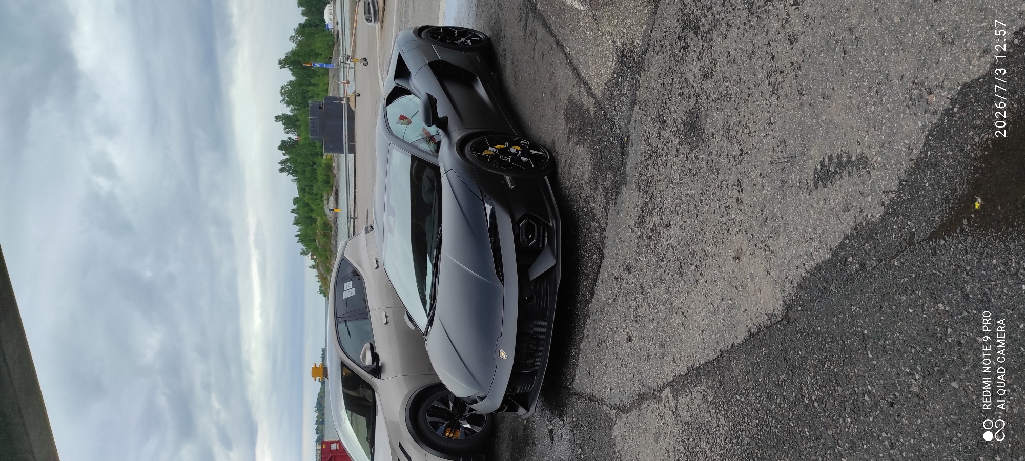 Matte black Lamborghini parked waterside in Helsinki