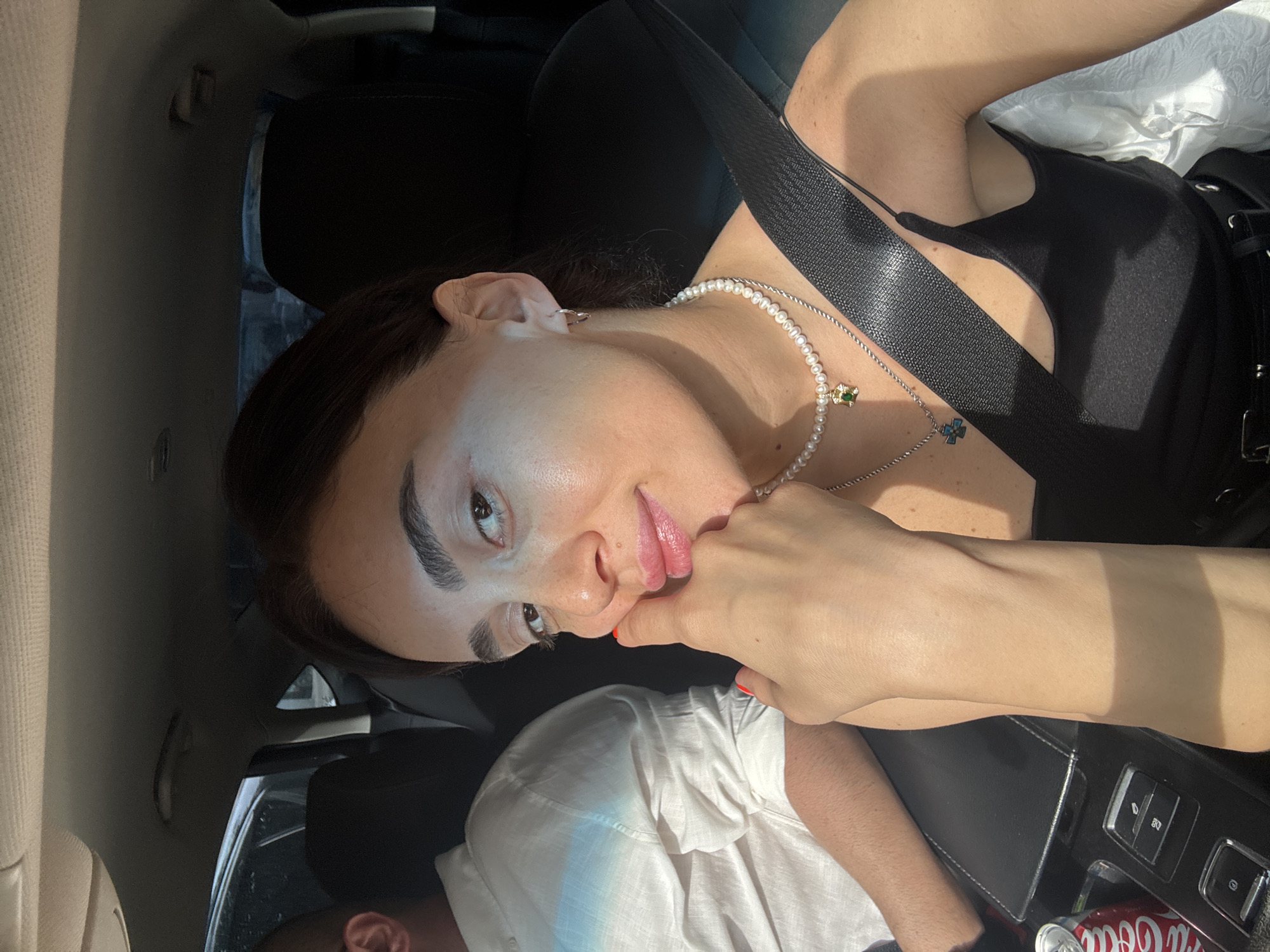 Woman takes selfies during early morning car ride through Tbilisi