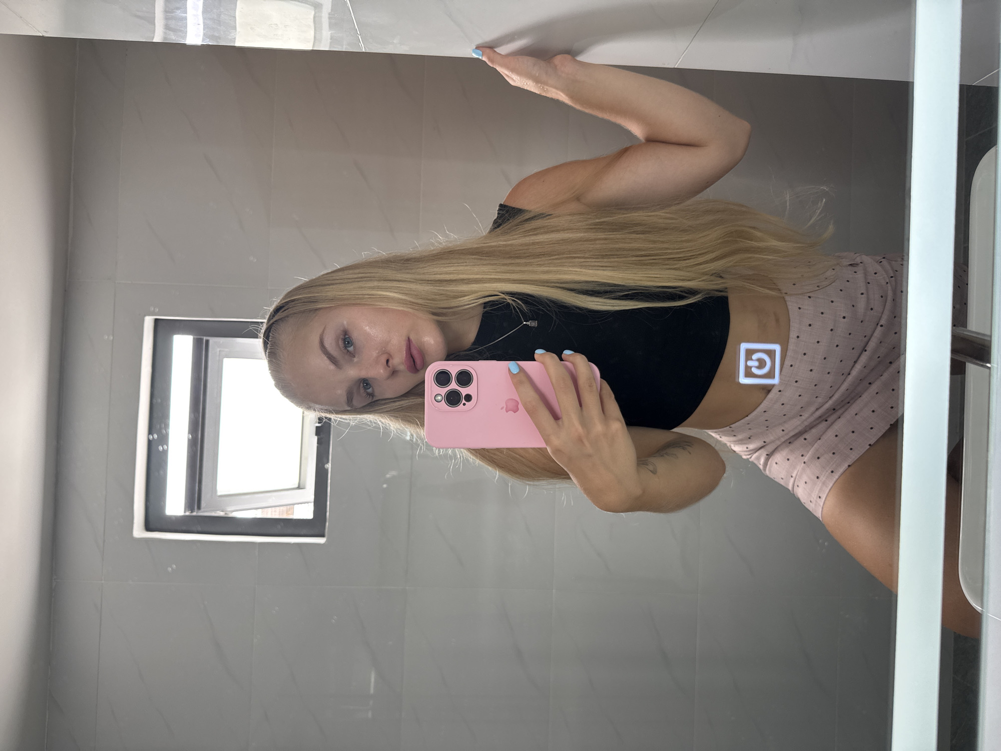Mirror selfies in a Nha Trang hotel room, pink skirt outfit