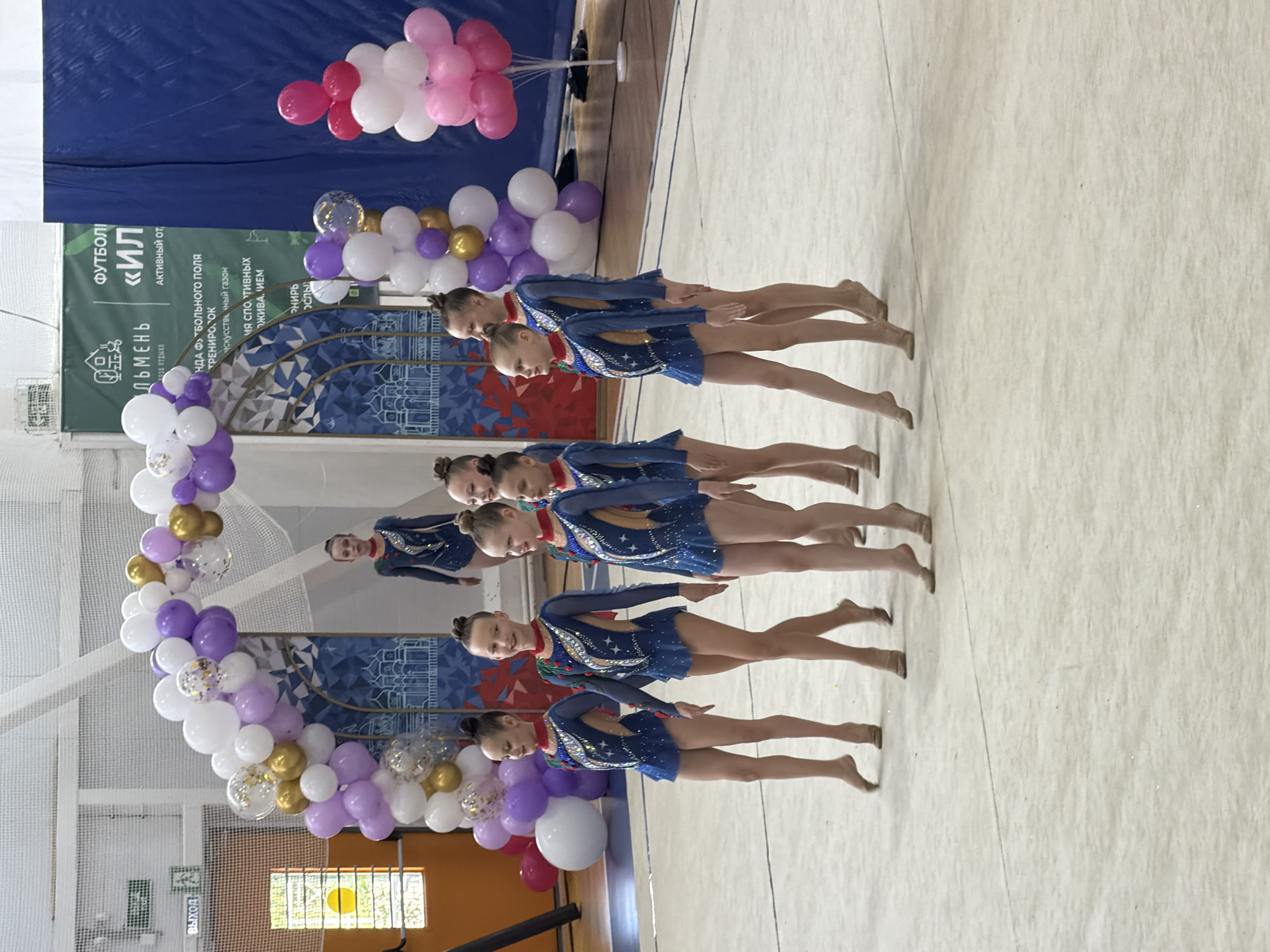 Young gymnasts and cheerleaders perform routines in Veliky Novgorod gymnasium