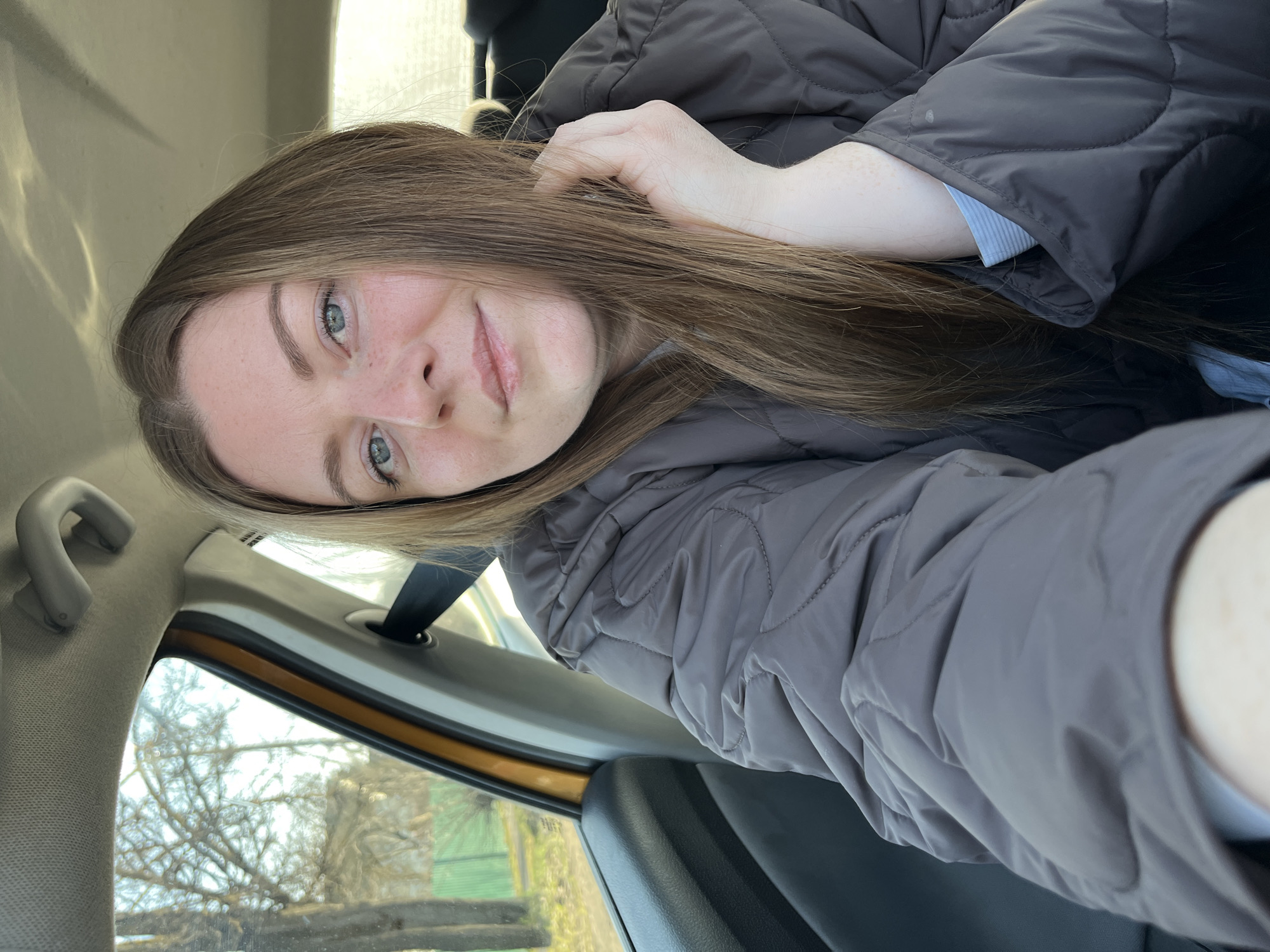 Woman takes selfie in car in Maksimkovo, Russia