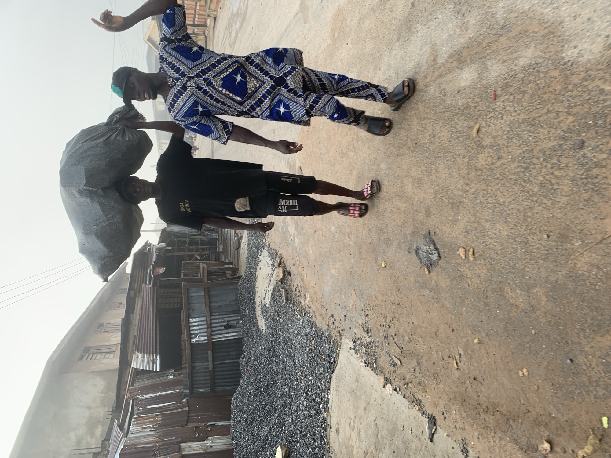 Morning street life in Shagamu, Nigeria — people moving, motorcycles rolling