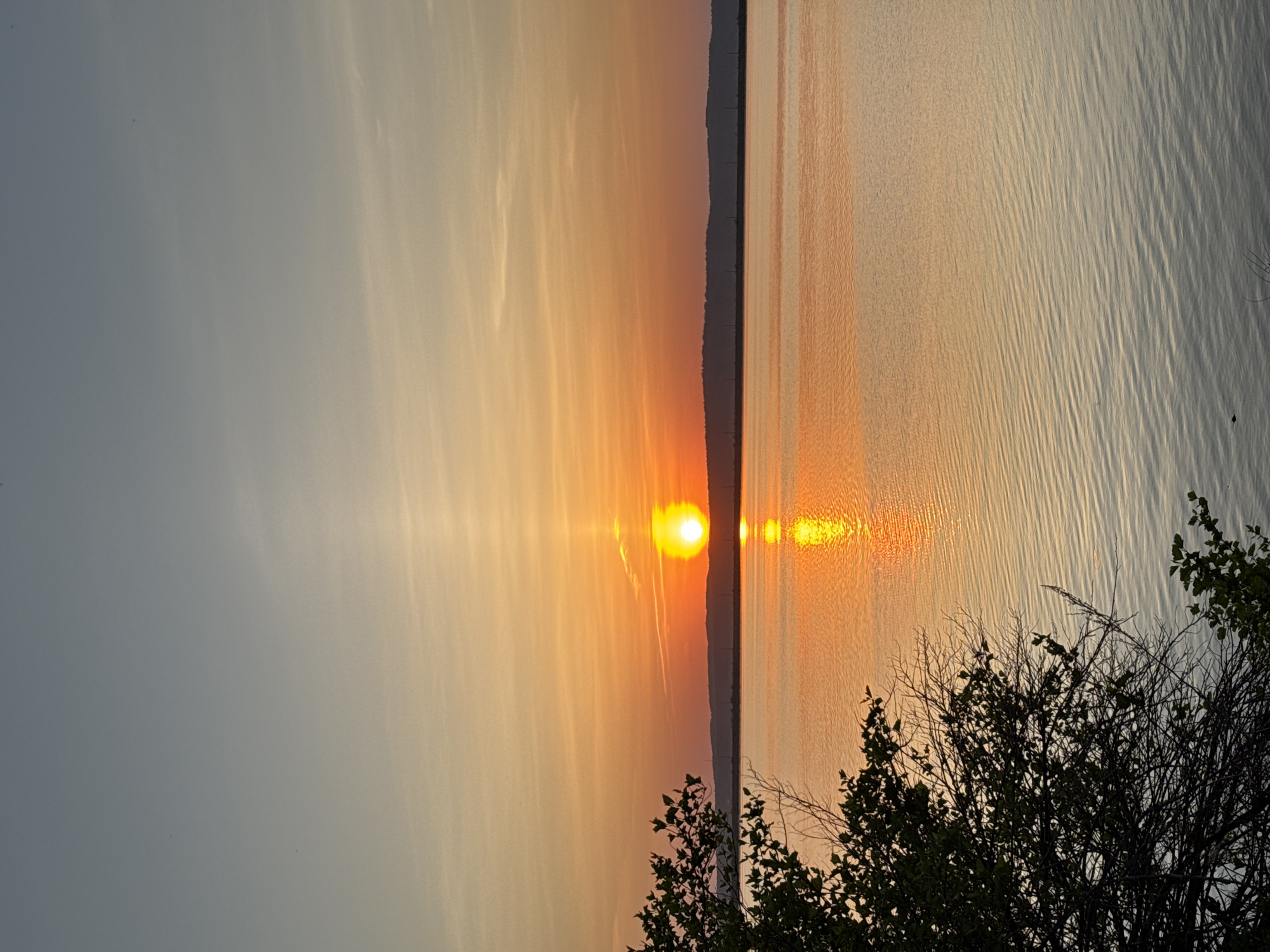 Woman enjoys riverside sunset in Chaikovsky, Russia