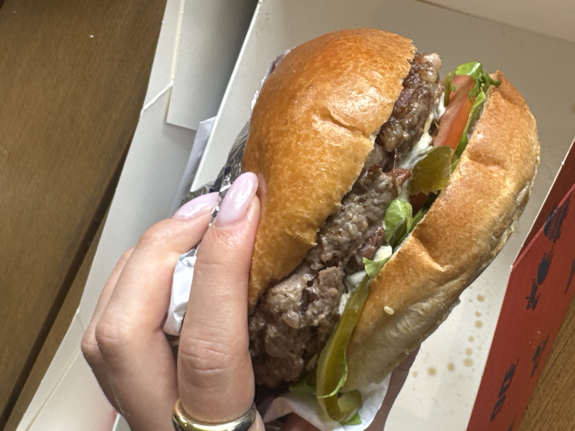Partially eaten hamburger documented in takeout container