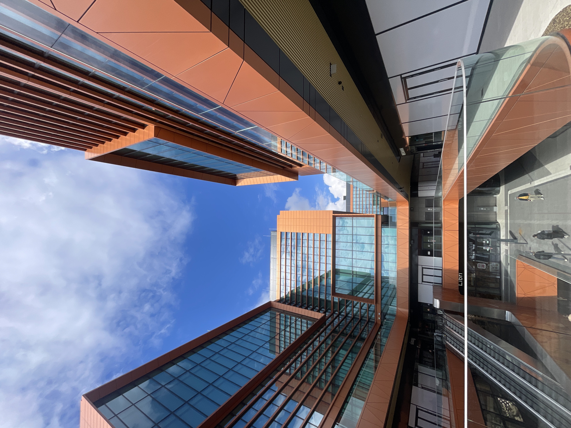 Visitor documents modern Budapest architecture complex in afternoon photo session