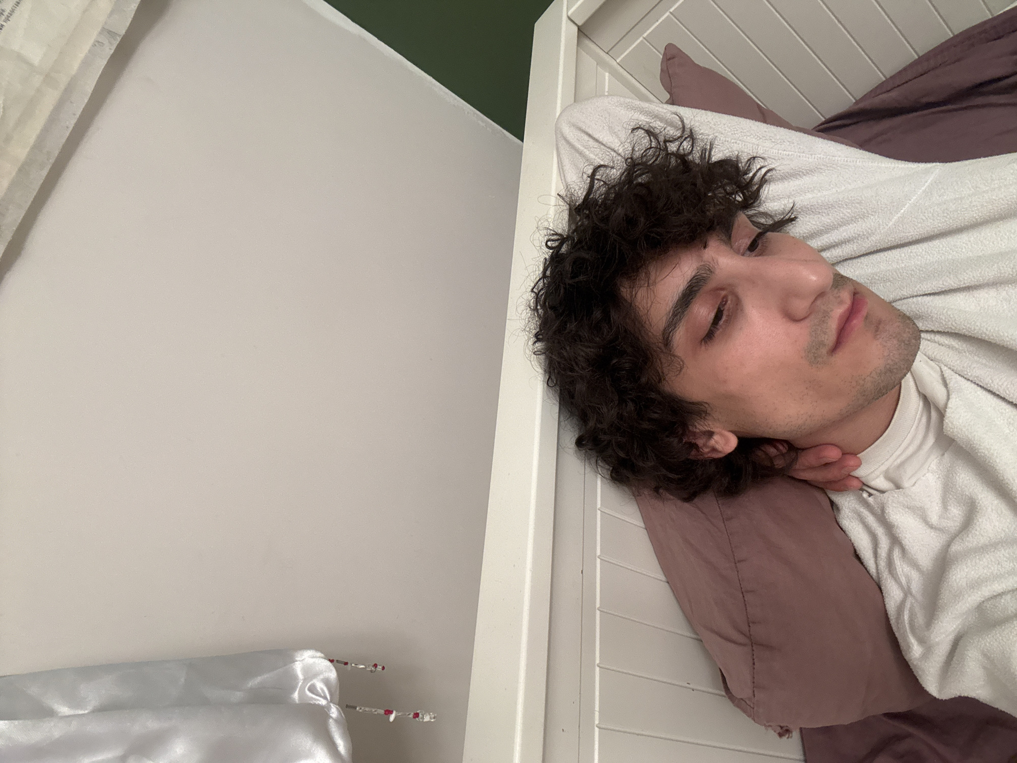 Young man resting in Moscow bedroom late evening