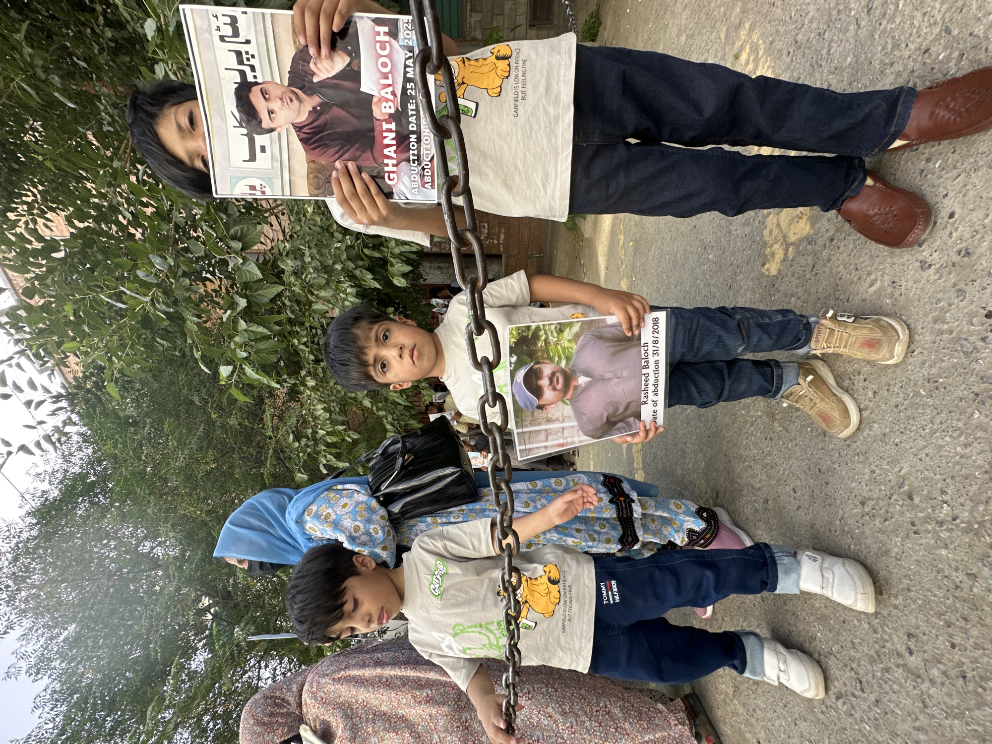 Families protest in Quetta holding photos of missing persons