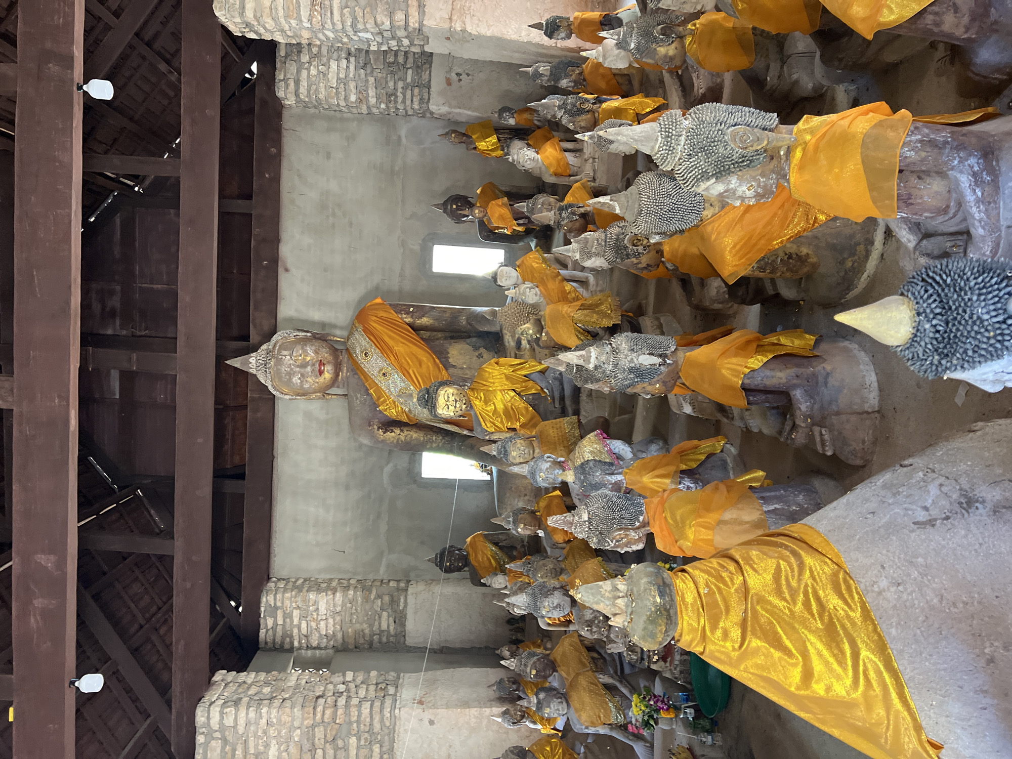 Visitors document Buddha statues at Baan Harn temple, Thailand
