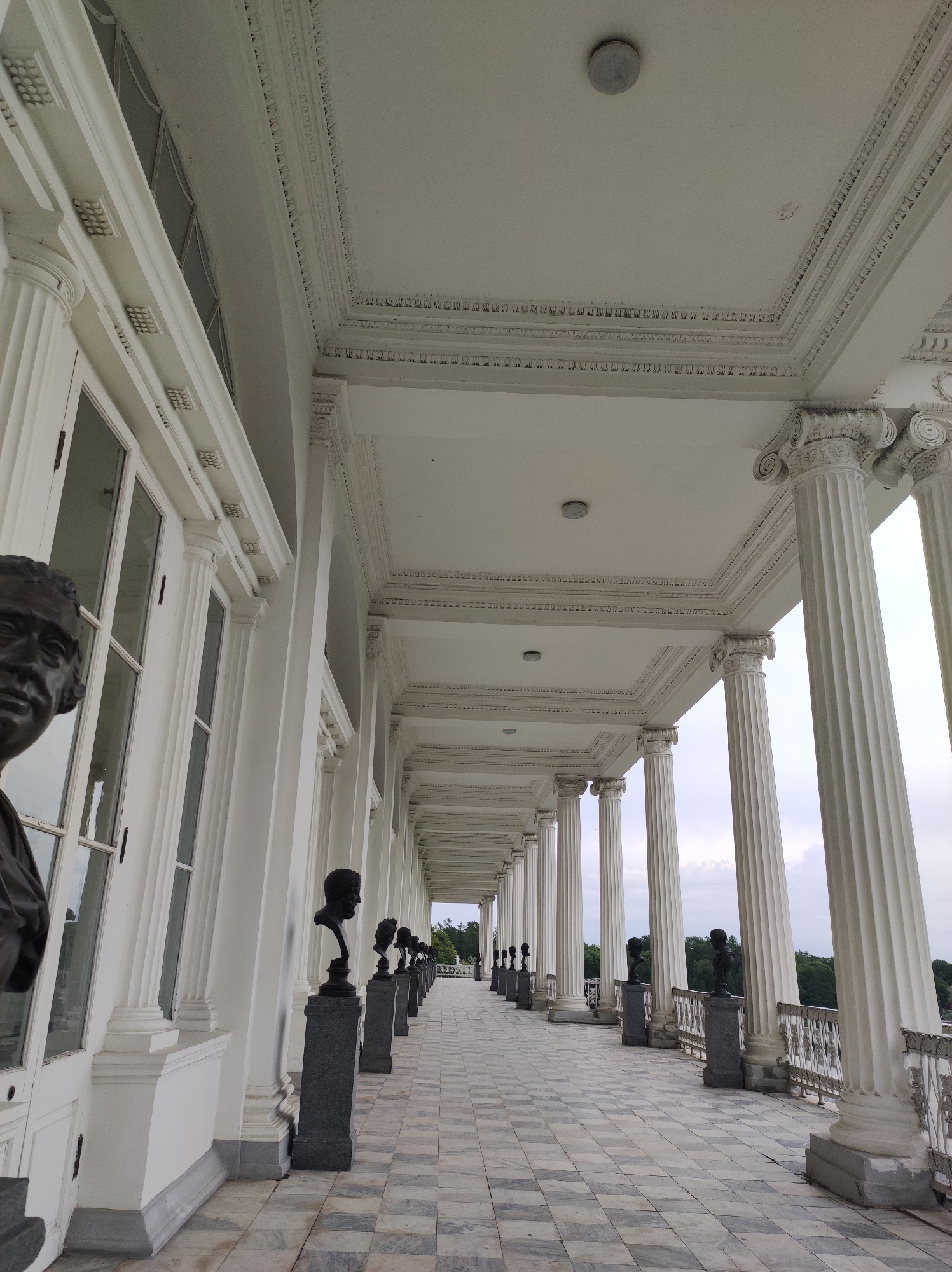 Family outing at a monumental civic landmark with sculptures and colonnades.