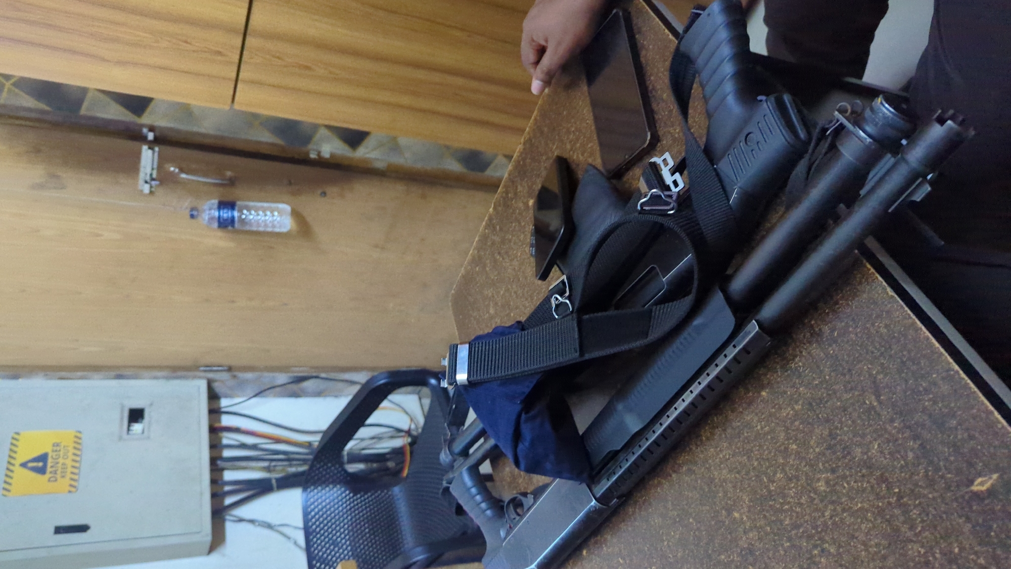 Table with shotgun and equipment observed in Dhaka