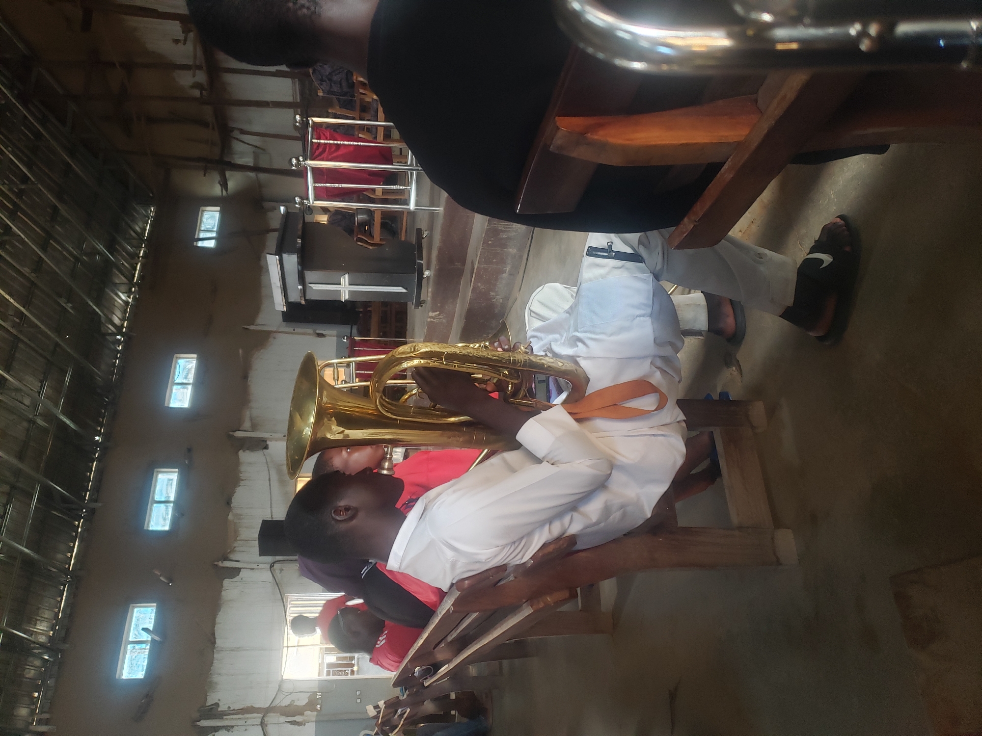Indoor gathering with tuba player in community space