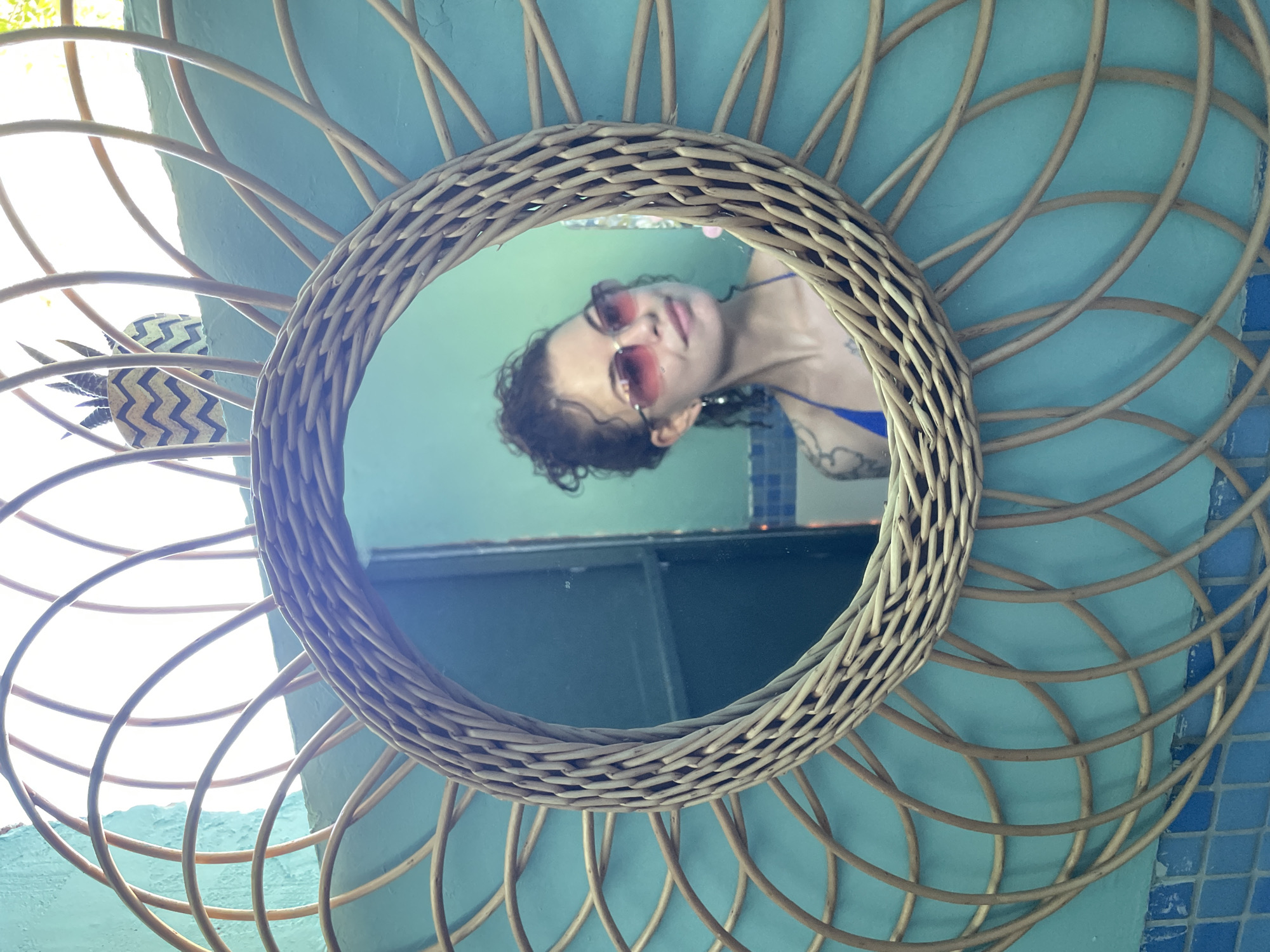 Blue bikini, rattan mirror, and a paddleboard on the Adriatic