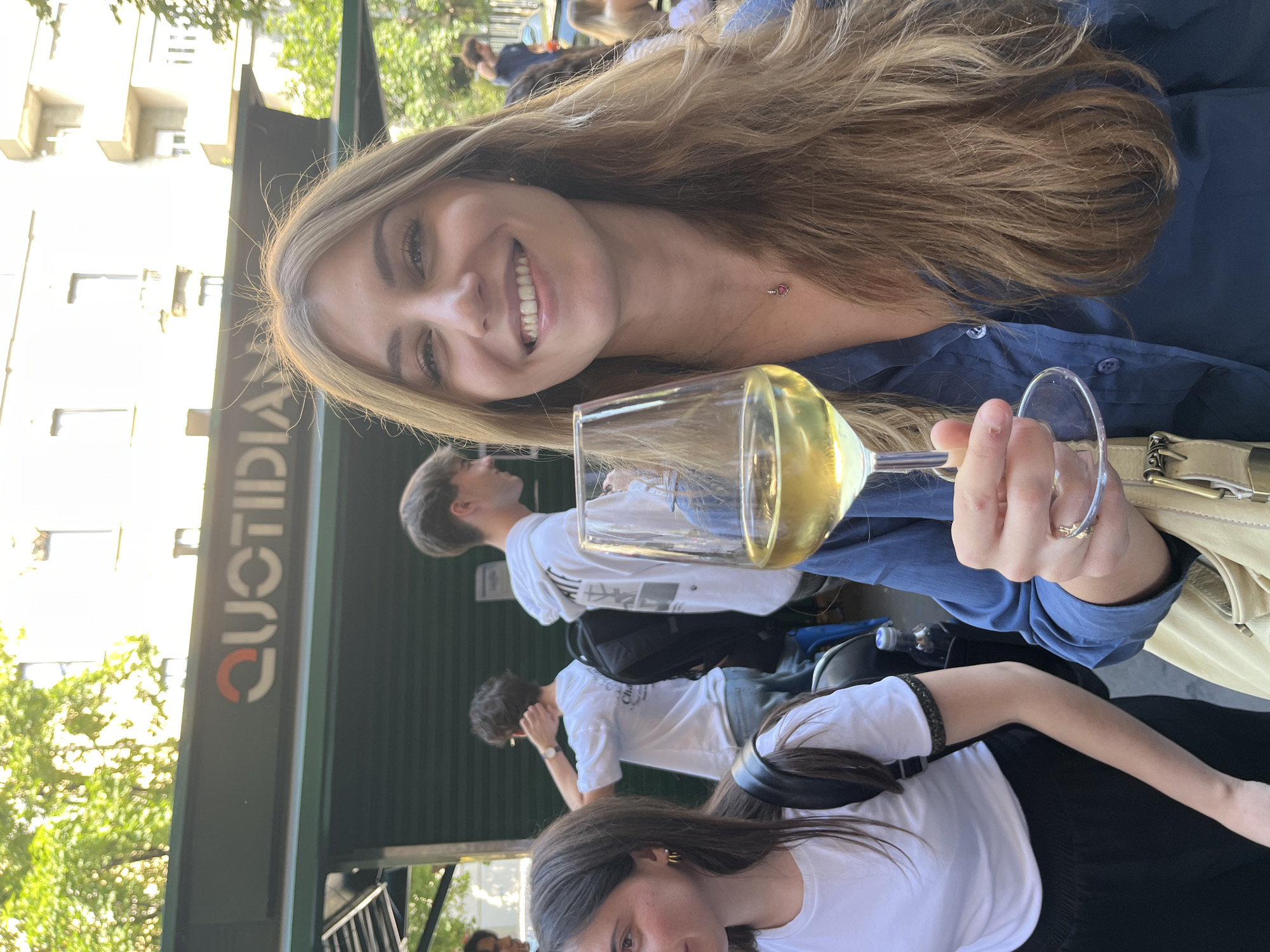 Woman enjoys white wine in Milan afternoon