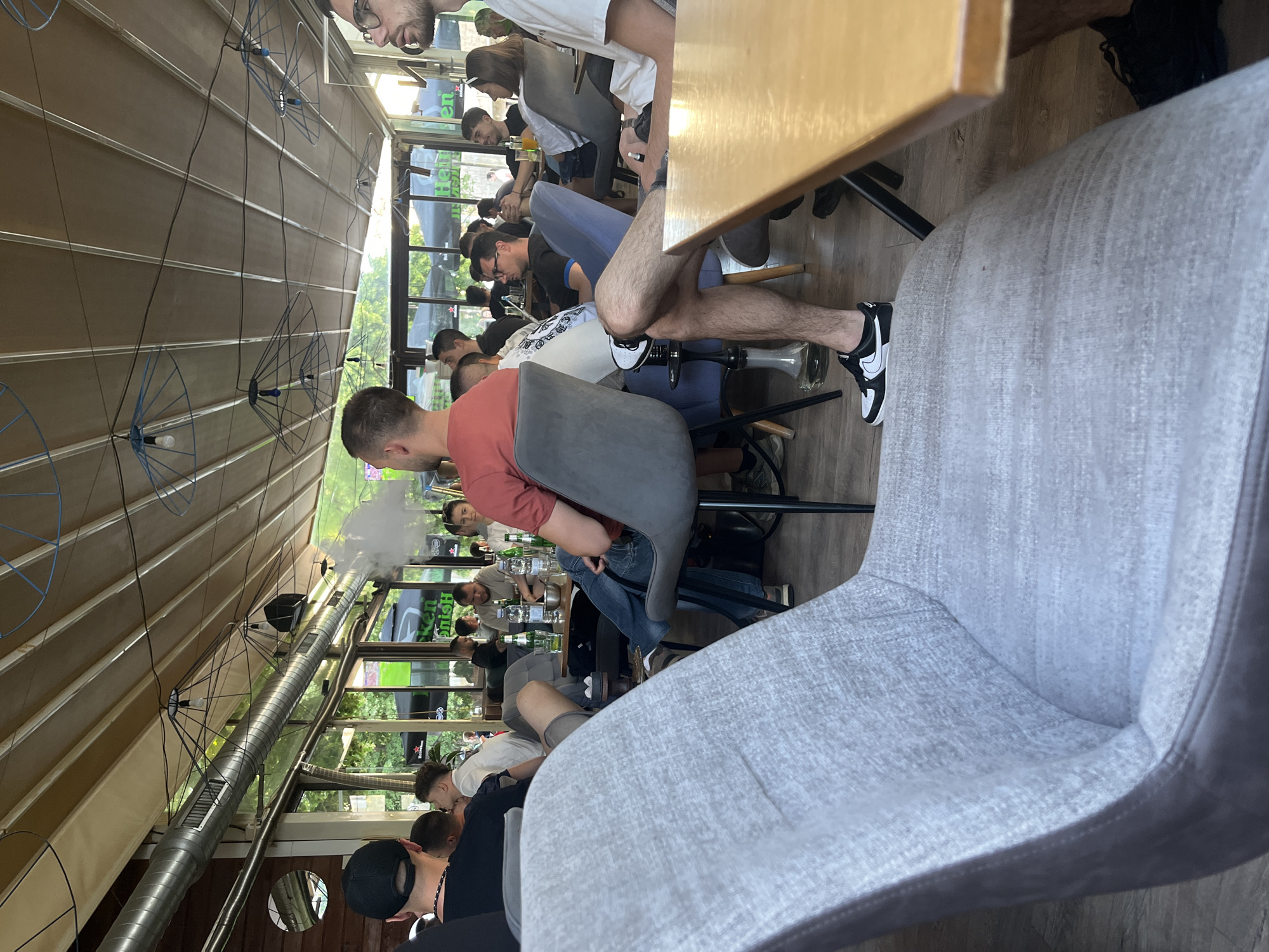 Crowded cafe with glass ceiling captured by witness