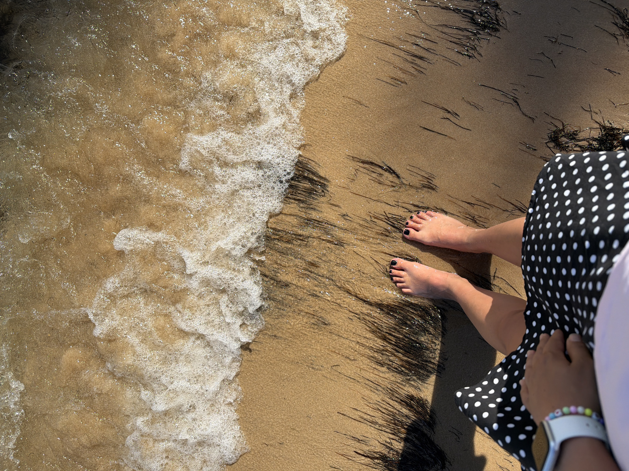 Setúbal's shoreline: sand, anchored boats, and estuary rock formations