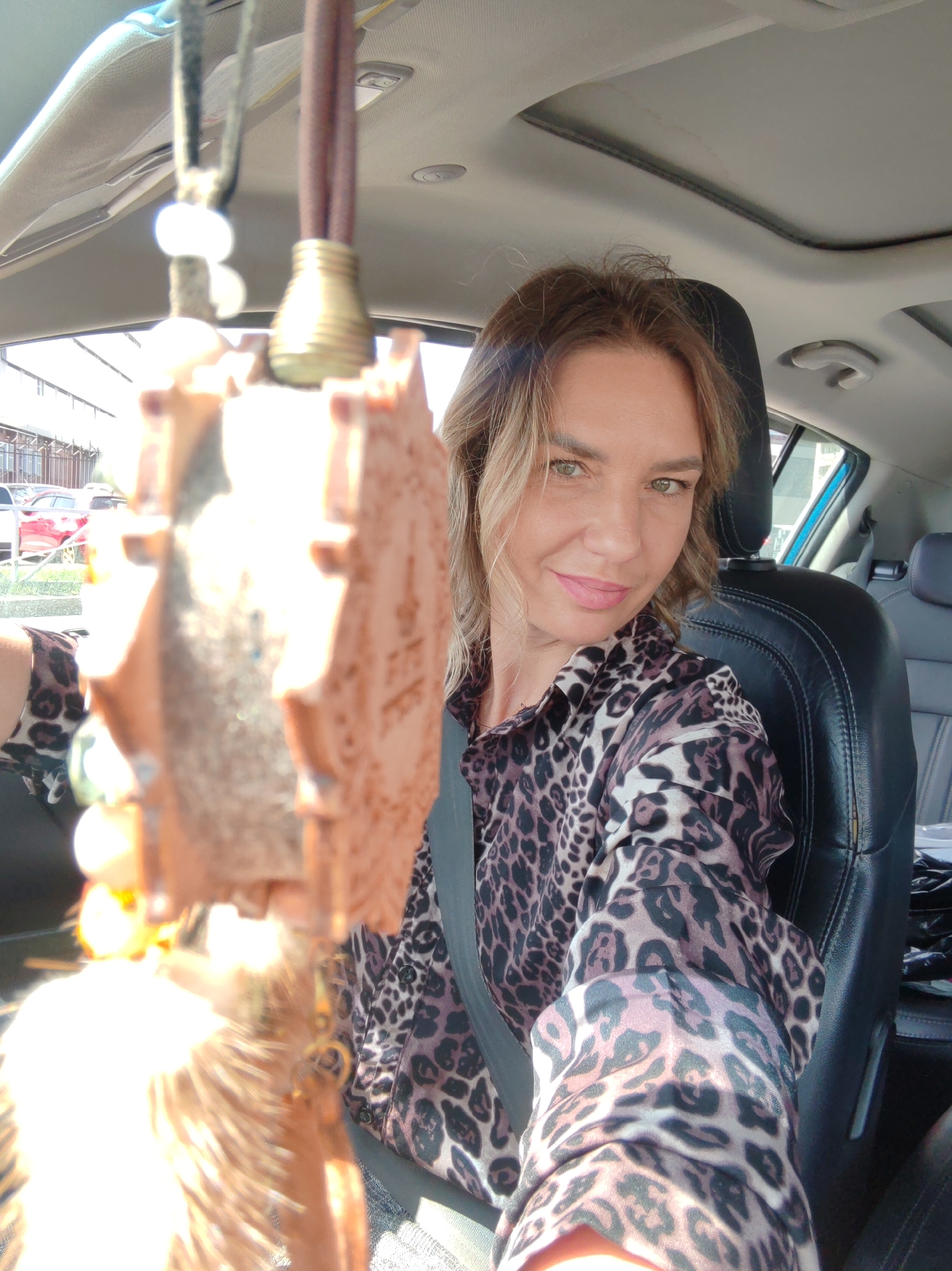 Woman takes car selfies in Petropavlovsk-Kamchatsky during early morning