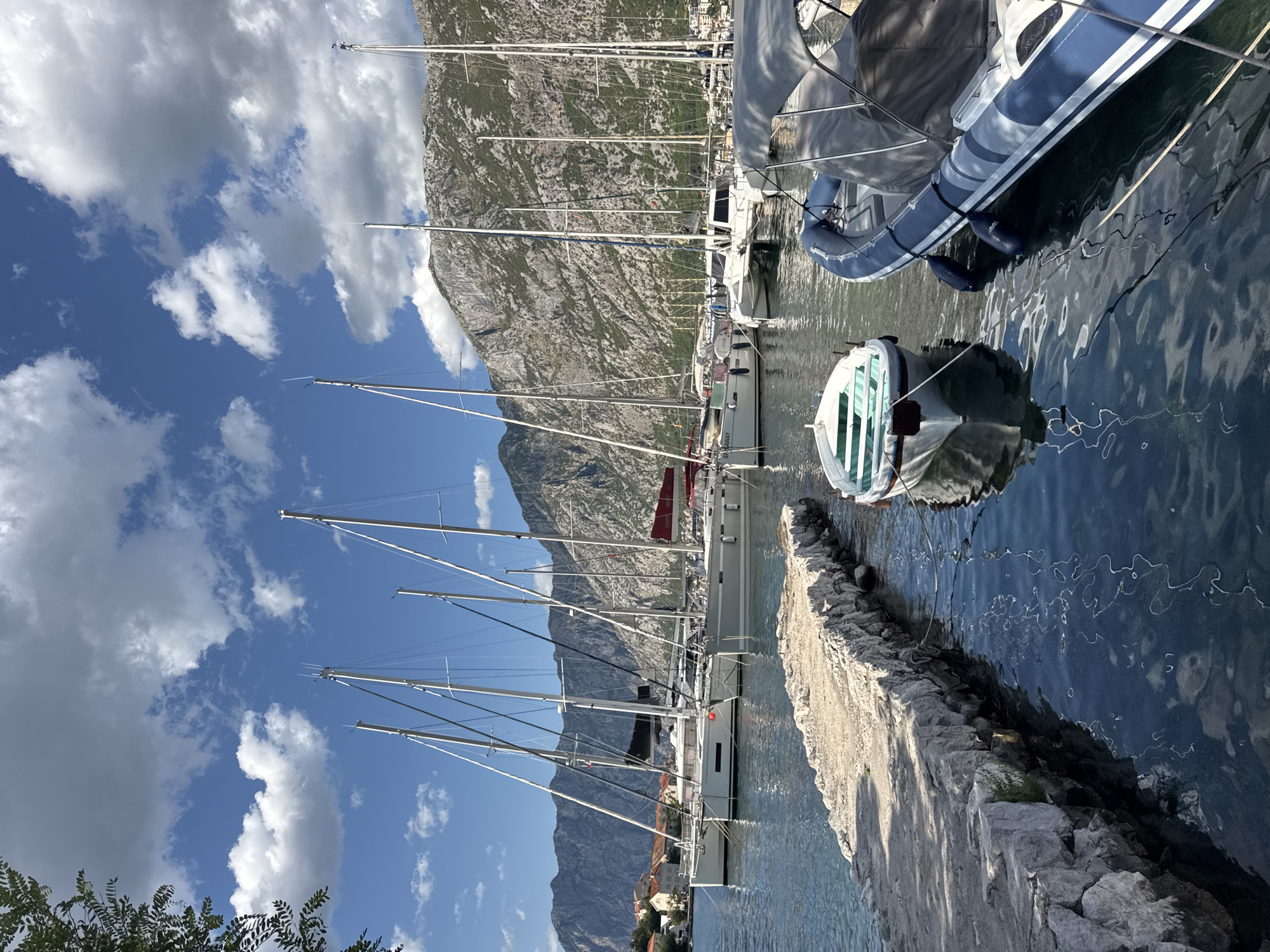 Sailboats moored on a quiet summer afternoon in Prčanj