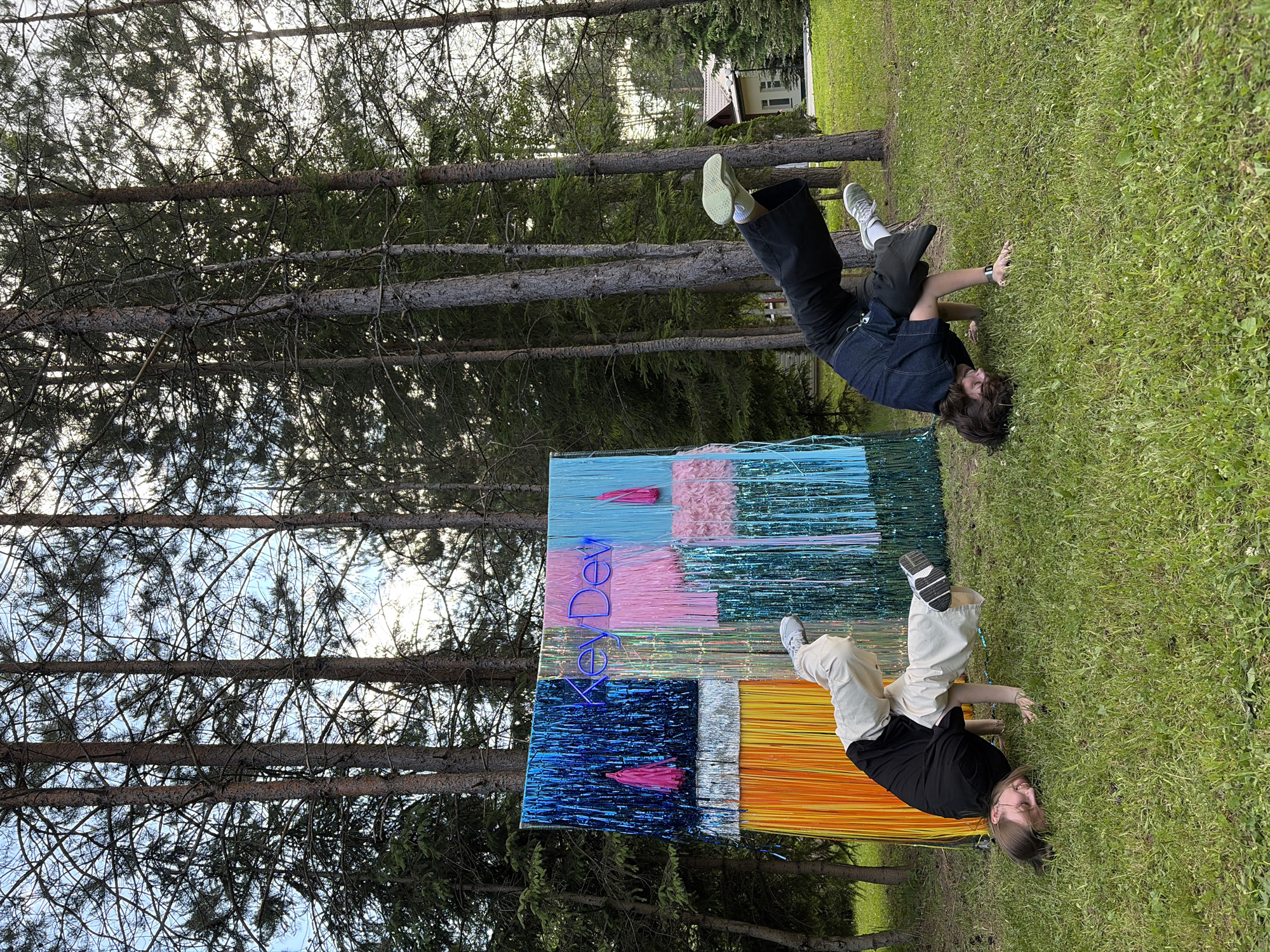 Outdoor KeyDev event with dancing and a tinsel backdrop near Minsk
