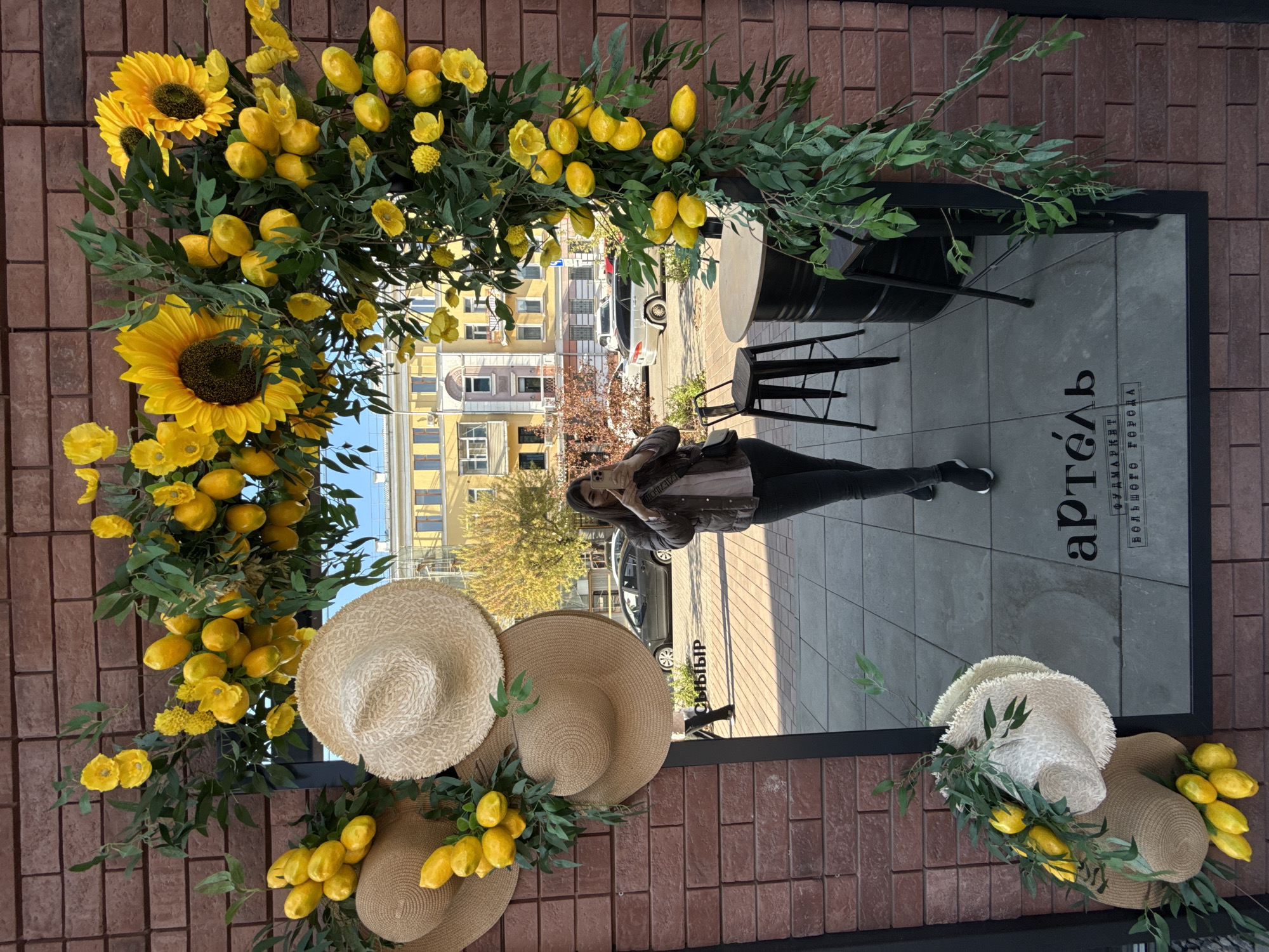 Ornate clock and floral displays observed on Krasnoyarsk building