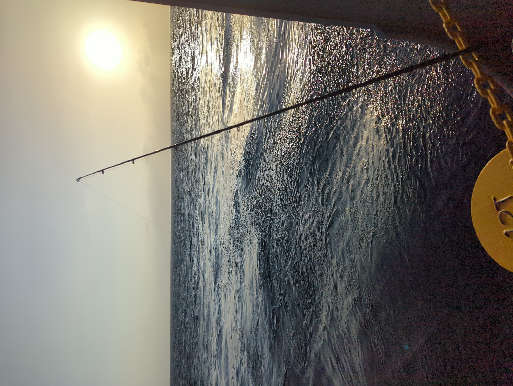 Fishing off Ussangoda at golden hour, rod over open ocean
