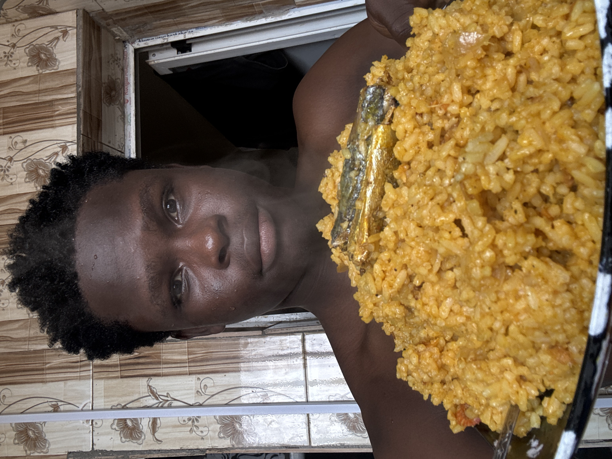 Jollof rice and whole fish served up in Ihiagwa, Nigeria