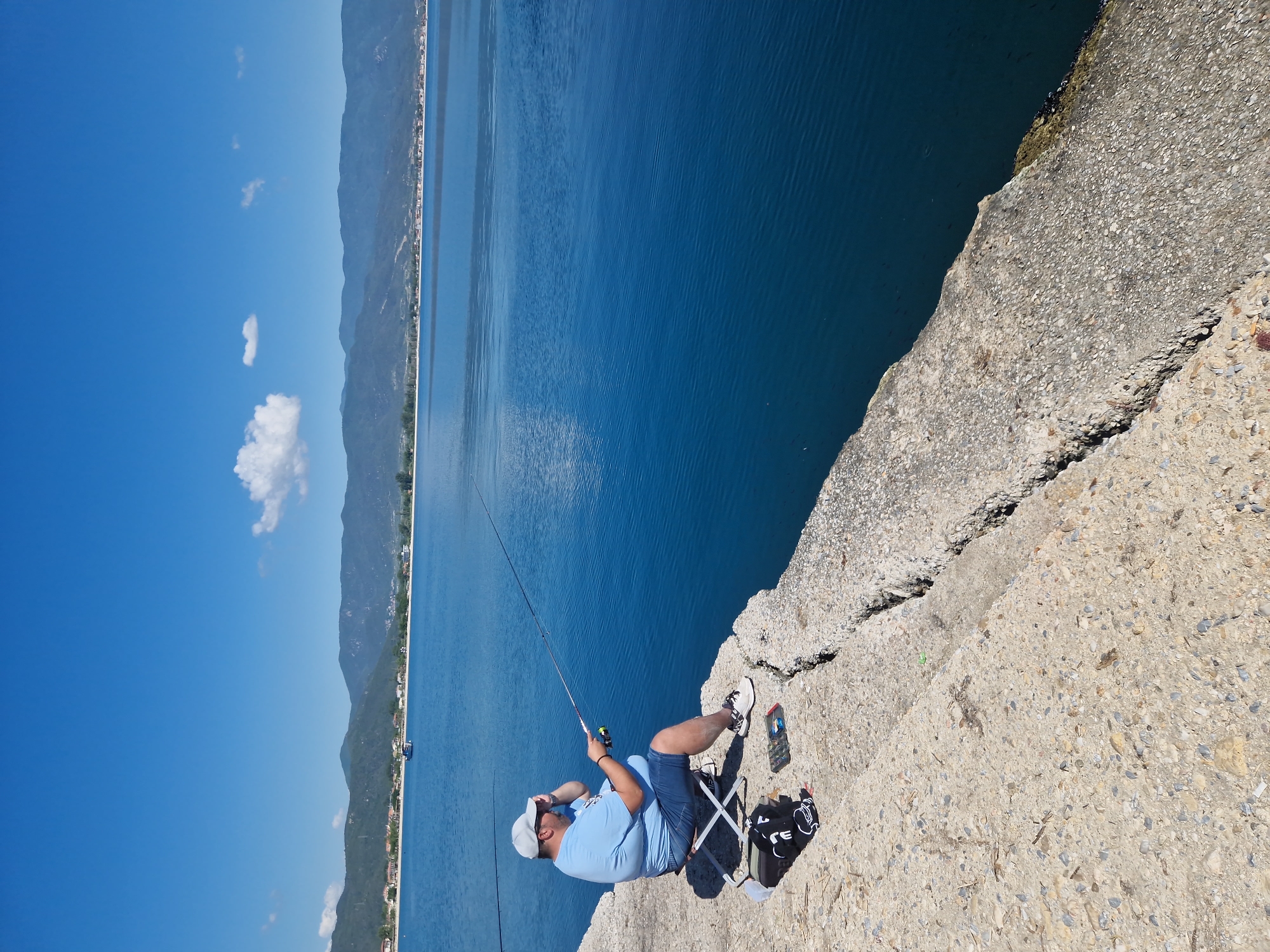 Morning fishing session observed at Greek harbor pier