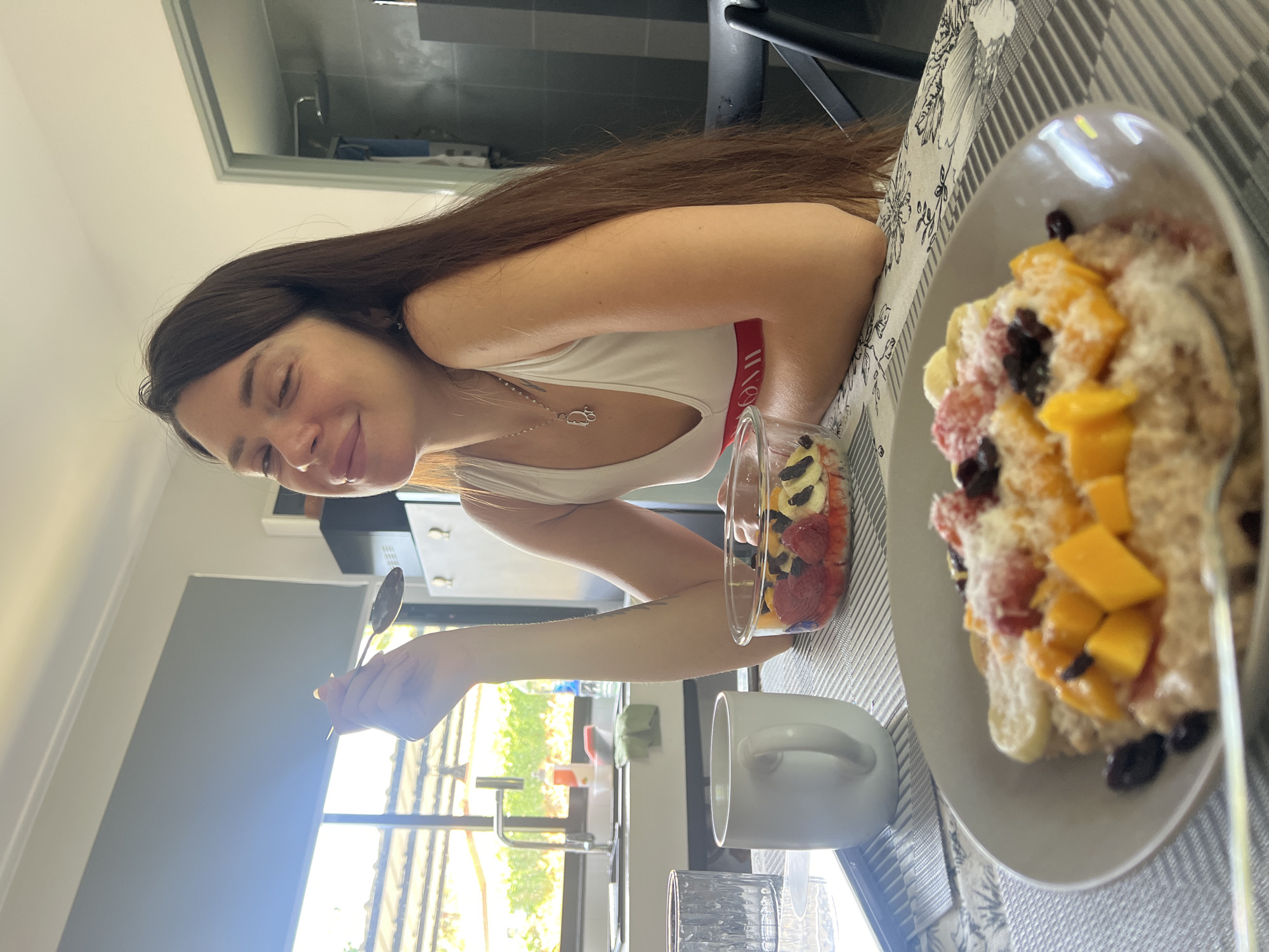 Woman prepares fruit-topped oatmeal breakfast in Thai kitchen
