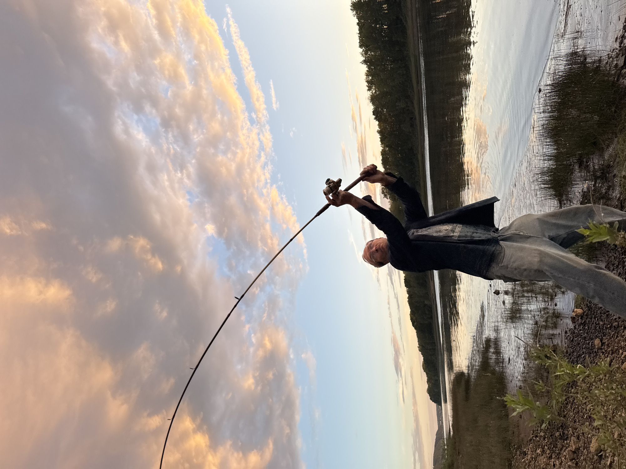 Evening fishing session on a Chaikovsky riverbank at golden hour